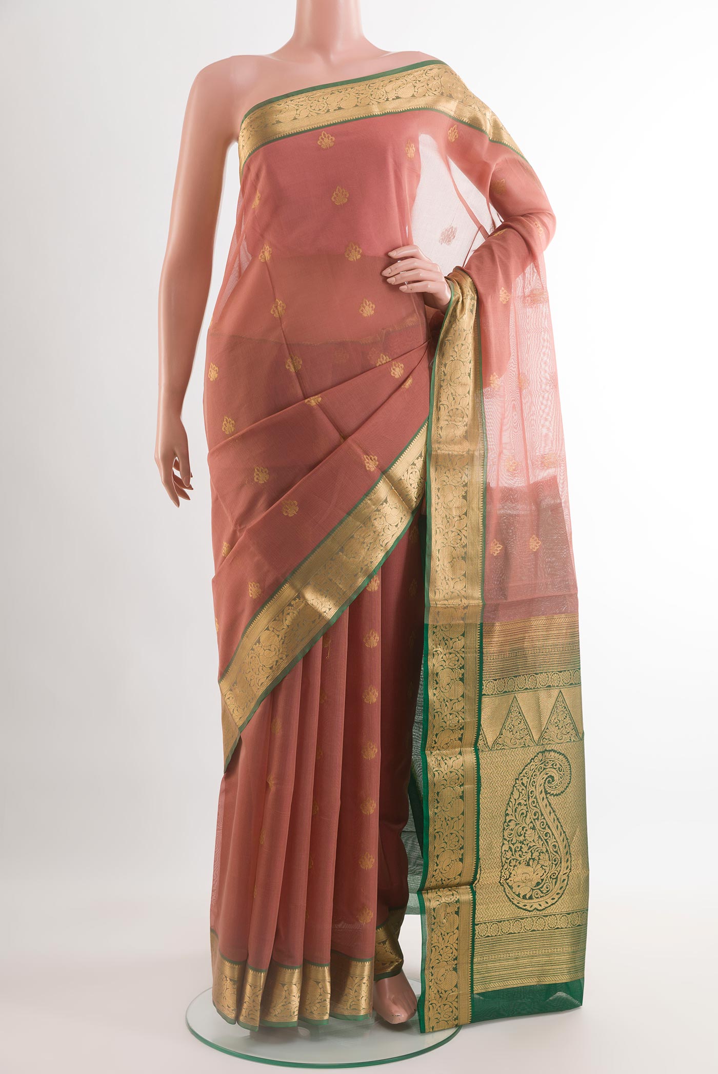 Peach Silk Cotton Saree with Zari Butta on the body and Zari Border.  displayed on a mannequin