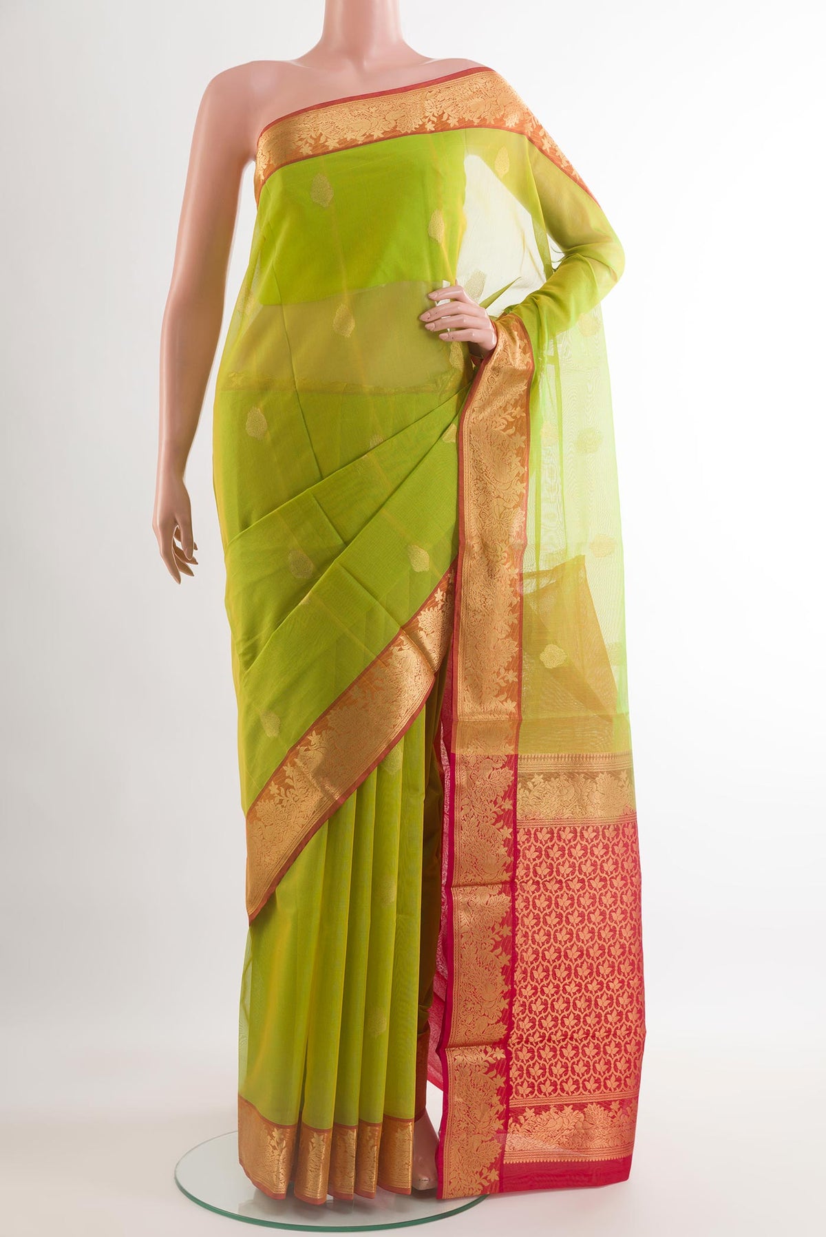 Parrot Green Silk Cotton Saree with Zari Butta on the body and Zari Border.  displayed on a mannequin