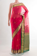 Pink Silk Cotton Saree with Zari Butta on the body and Zari Border.  displayed on a mannequin
