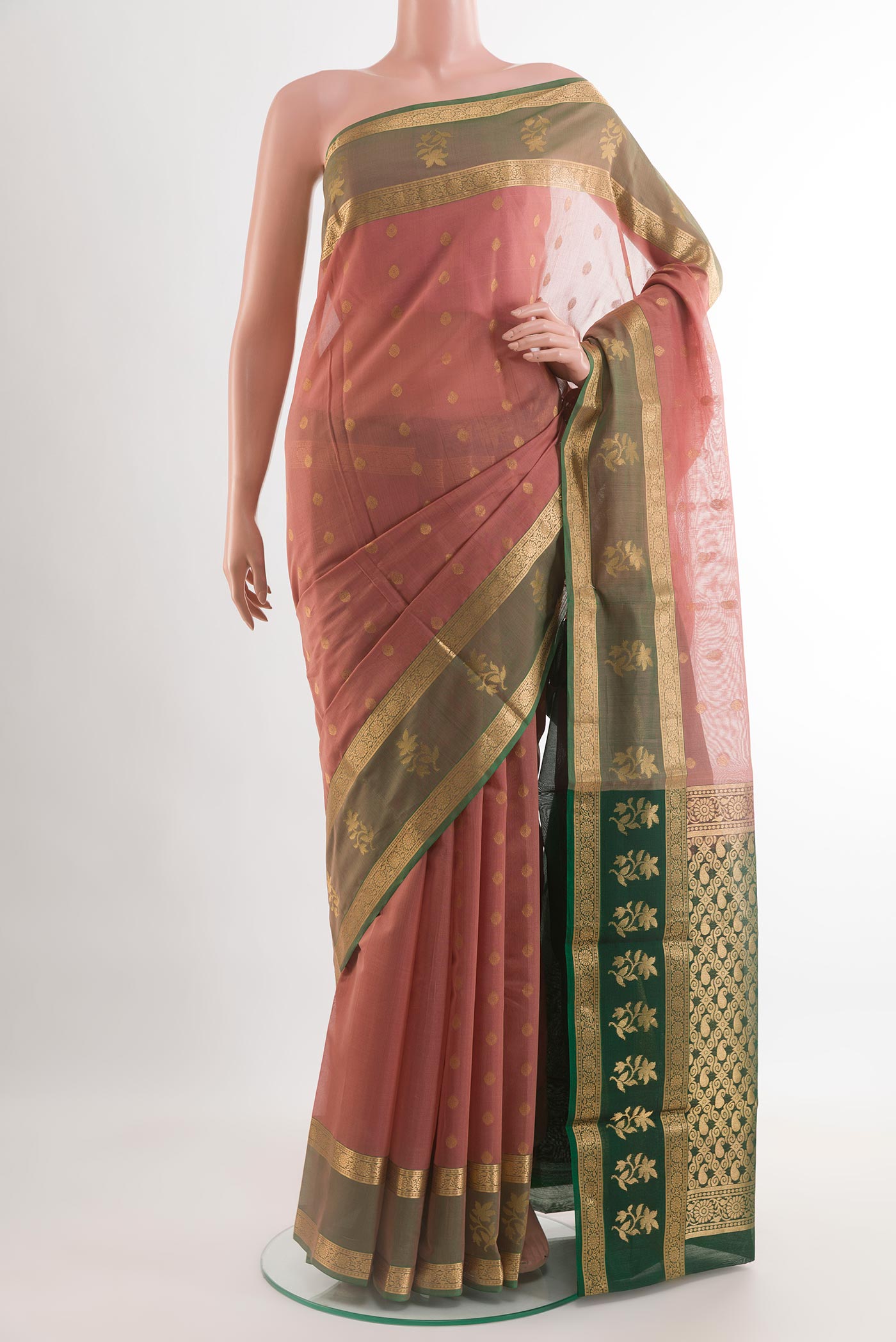 Peach Silk Cotton Saree with Zari Butta on the body and Zari Border.  displayed on a mannequin