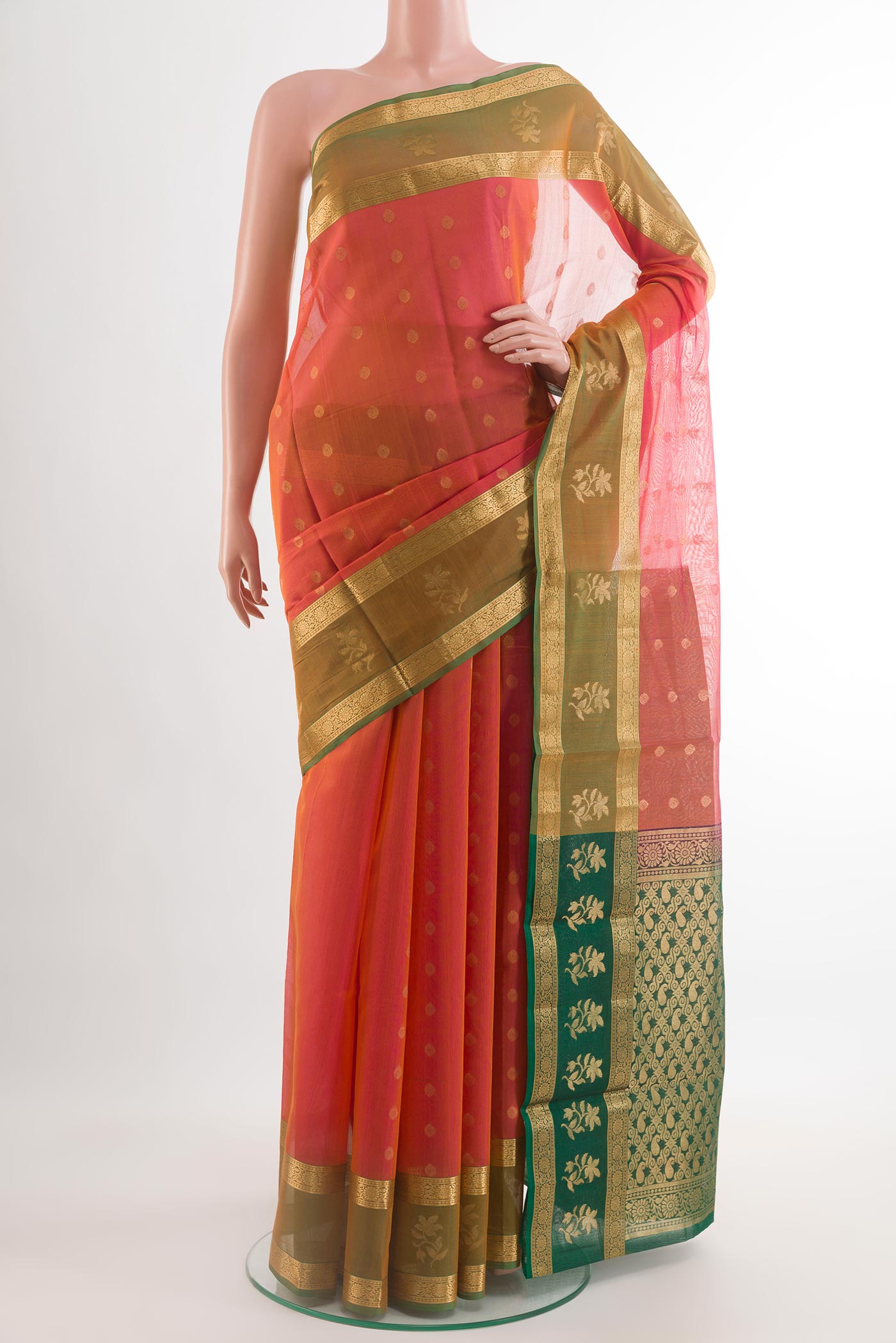 Coral Silk Cotton Saree with Zari Butta on the body and Zari Border.  displayed on a mannequin
