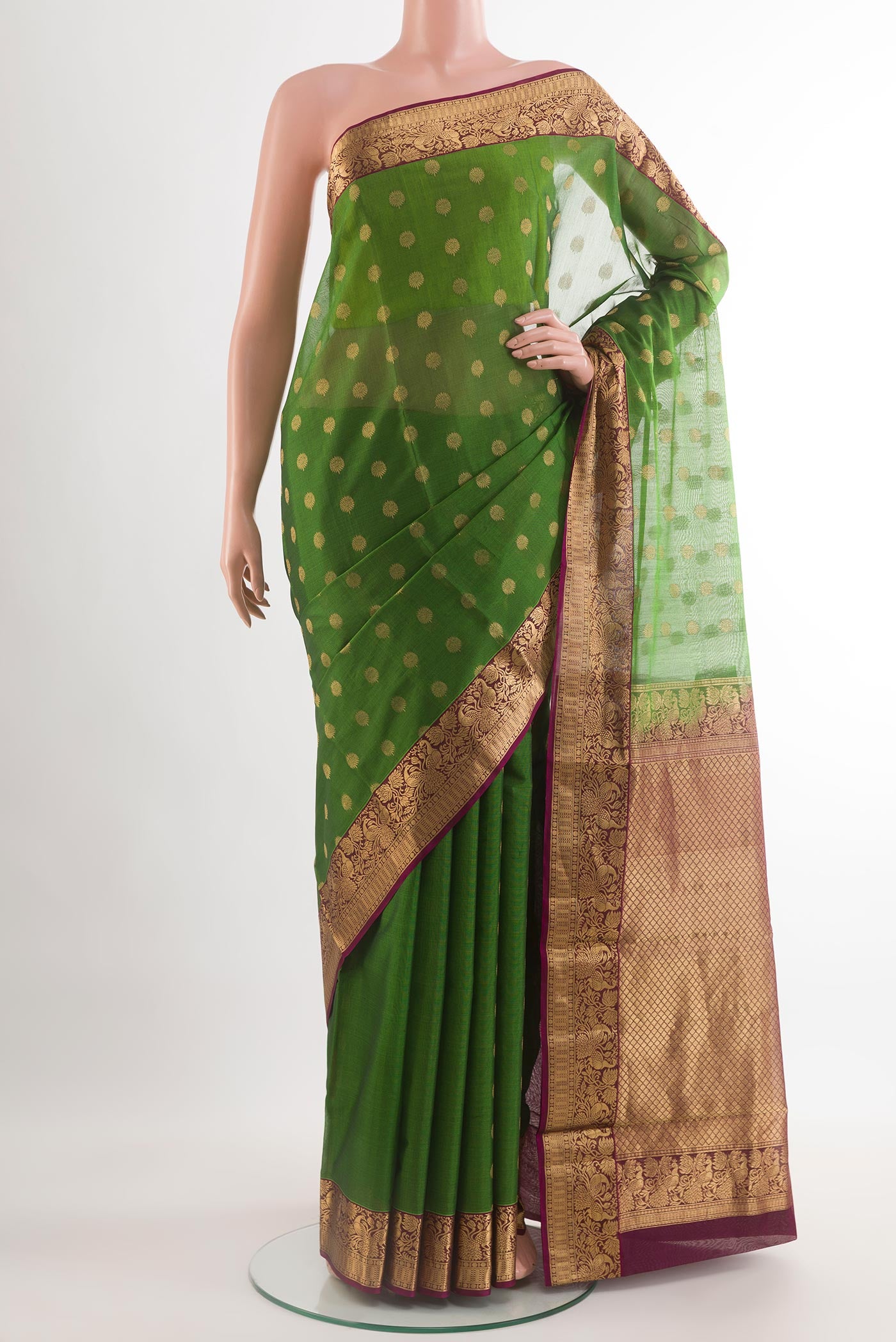Green Silk Cotton Saree with Zari Butta on the body and Zari Border.  displayed on a mannequin