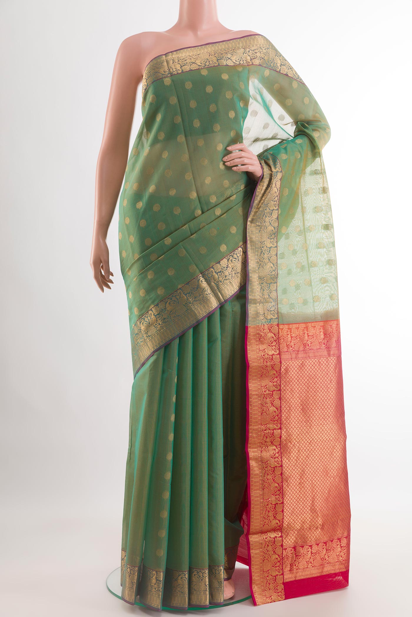 Light Green Blended Kora Cotton Saree with Zari Butta on the body and Zari Border.  displayed on a mannequin