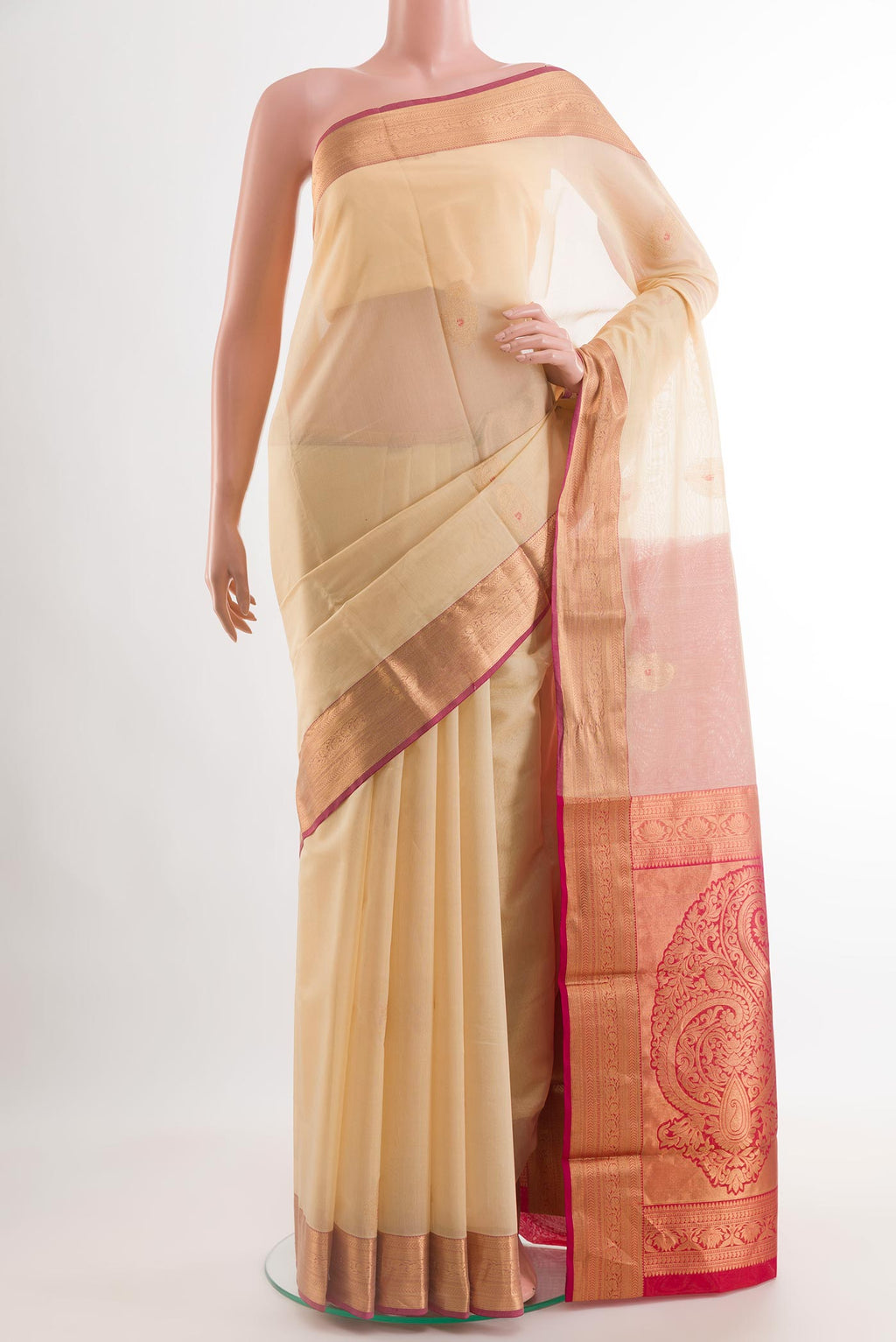 Beige Blended Kora Cotton Saree with Zari Butta on the body and Zari Border.  displayed on a mannequin