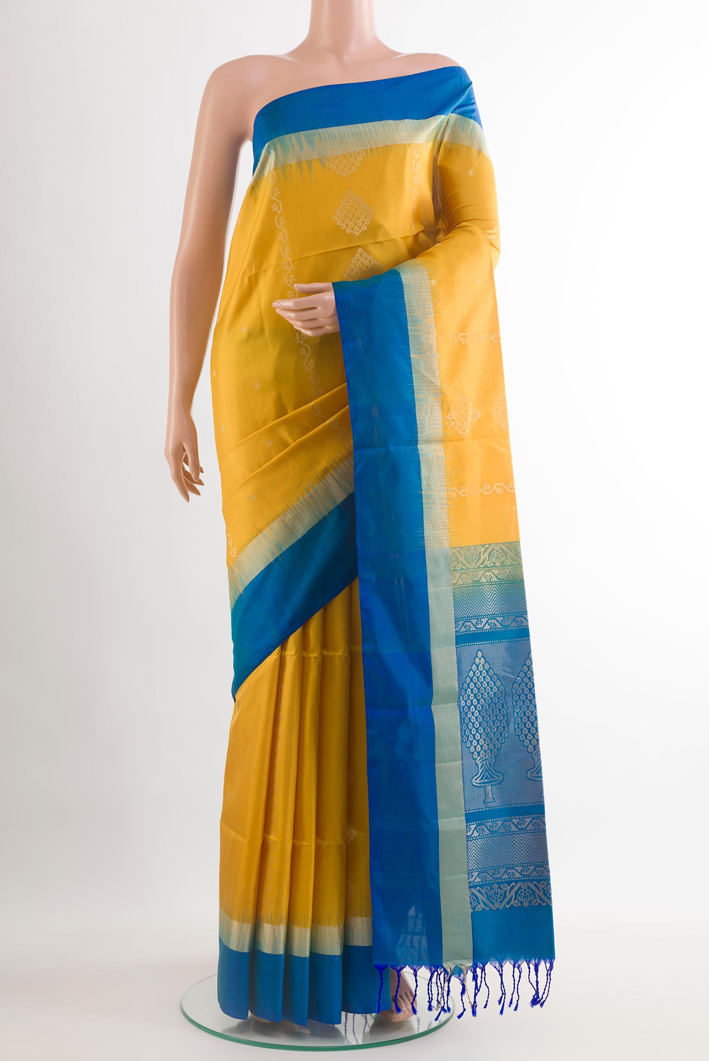 Yellow Soft Silk Saree with Zari Butta on the body and Zari Border.  displayed on a mannequin