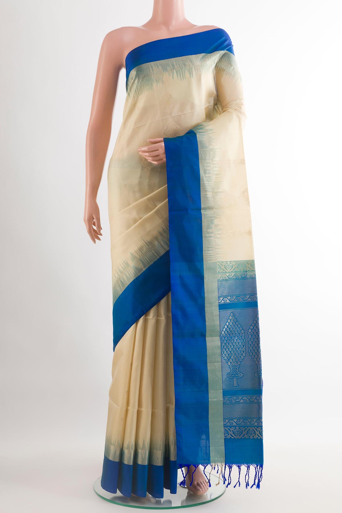 Cream Soft Silk Saree with Zari Butta on the body and Zari Border.  displayed on a mannequin