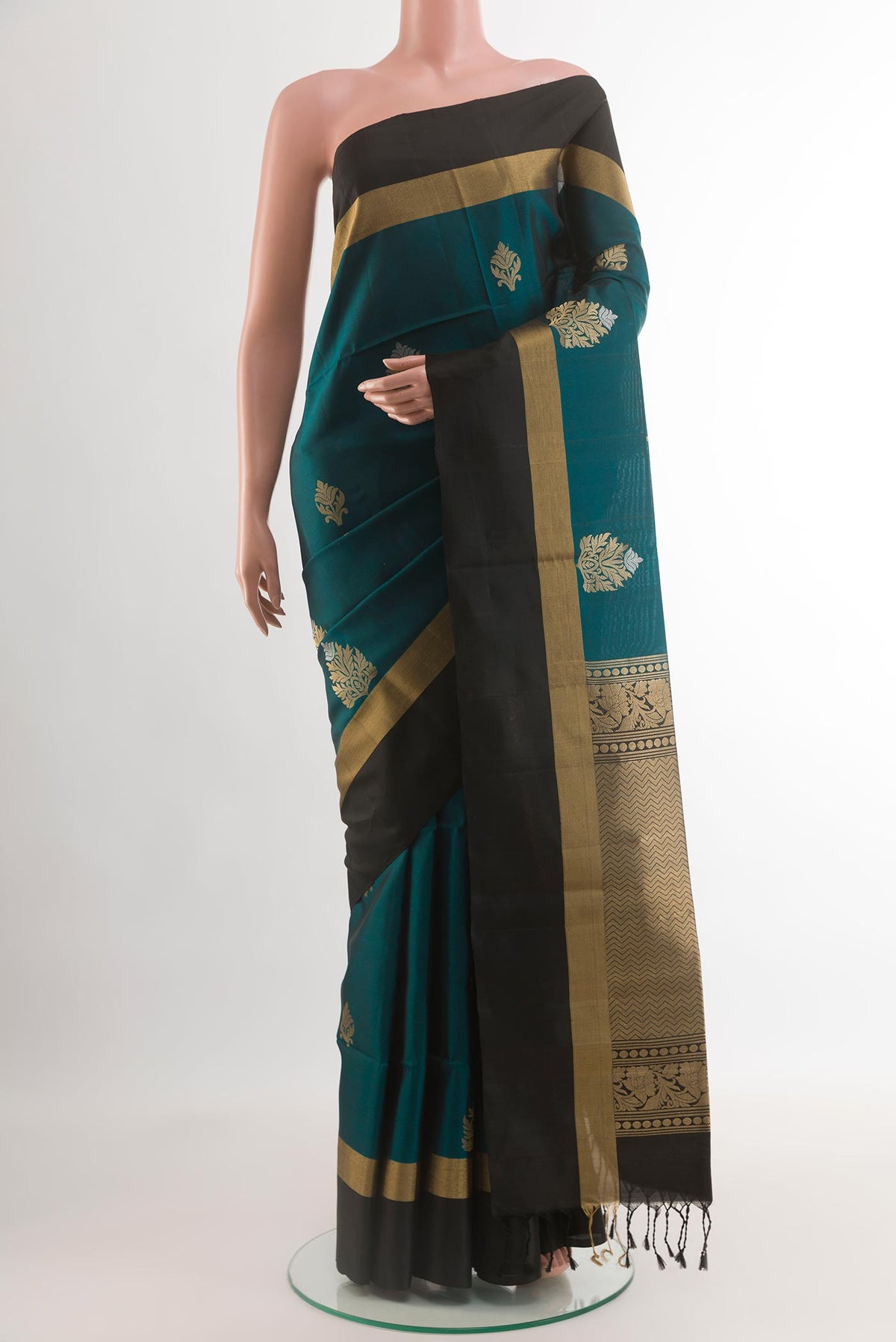 Teal Soft Silk Saree with Zari Butta on the body and Zari Border.  displayed on a mannequin