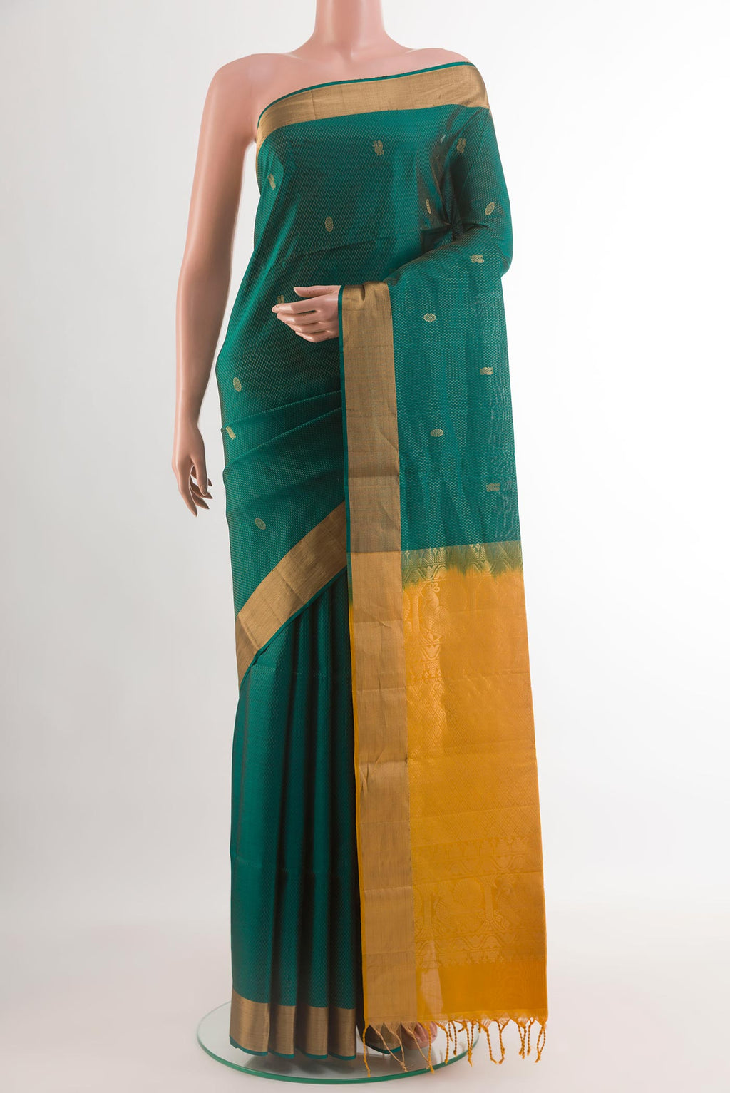 Teal Soft Silk Saree with Zari Butta on the body and Zari Border.  displayed on a mannequin