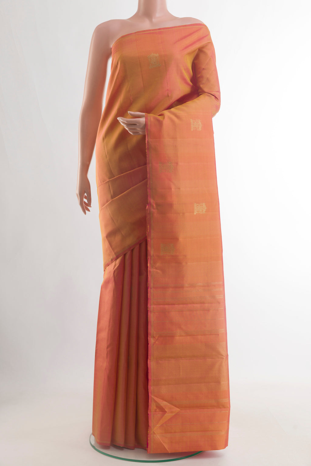 Pinkish Yellow Dual Tone Kanjivaram Silk Saree with Zari Butta on the body and Zari Border.  displayed on a mannequin