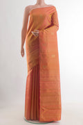 Pinkish Yellow Dual Tone Kanjivaram Silk Saree with Zari Butta on the body and Zari Border.  displayed on a mannequin