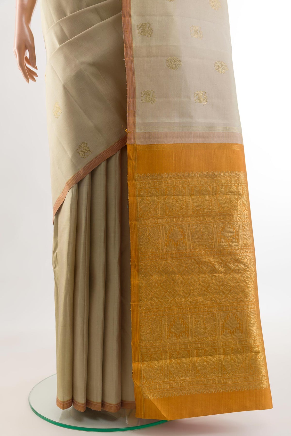 Pleats and pallu of Pure Silk Pure Zari Beige Kanchipuram Saree with Zari Butta on the body and Without Border. 