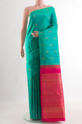 Turquoise Kanchipuram Silk Saree with Zari Butta on the body and Without Border.  displayed on a mannequin
