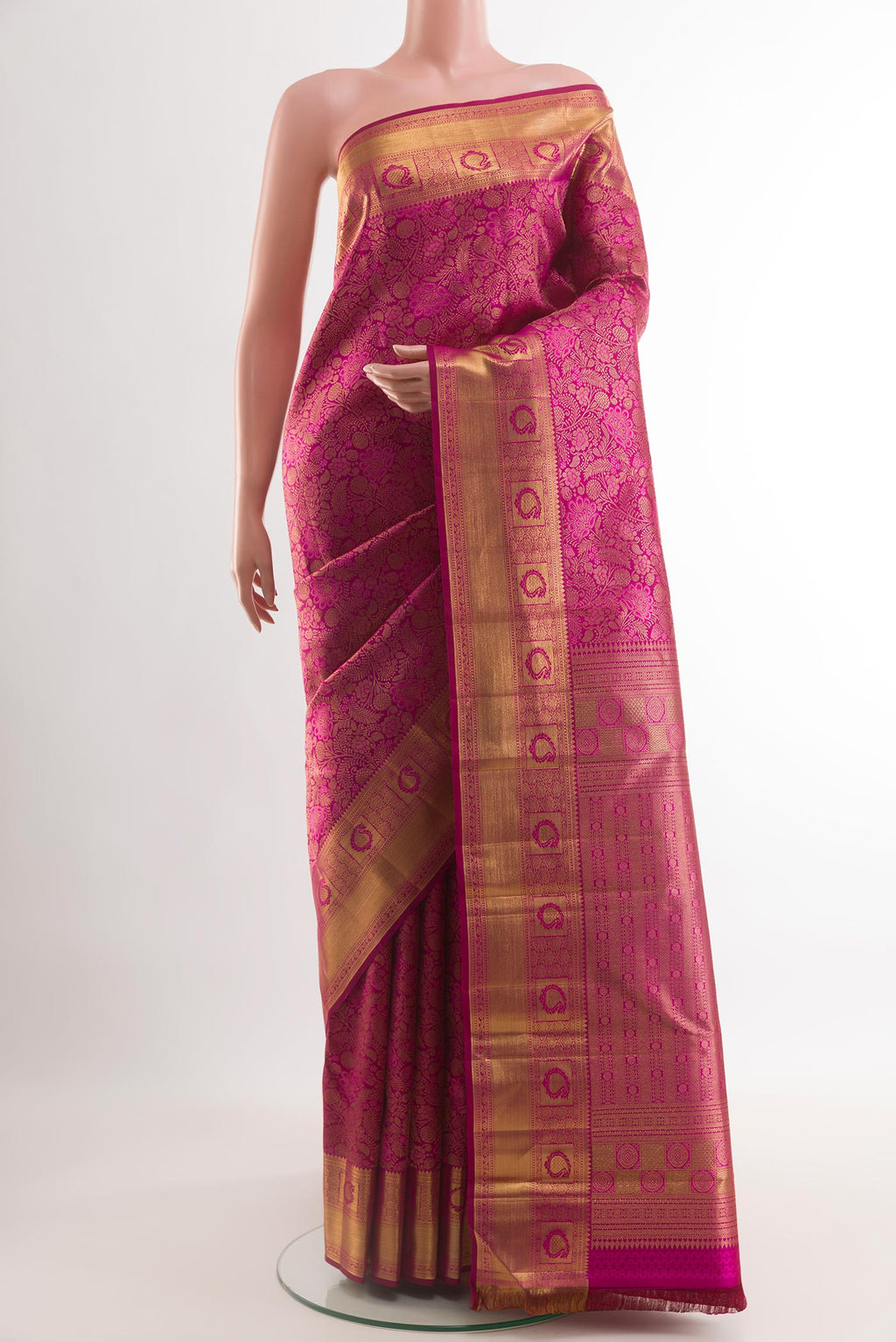Magenta Kanchipuram Silk Saree with Zari Brocade on the body and Zari Border.  displayed on a mannequin