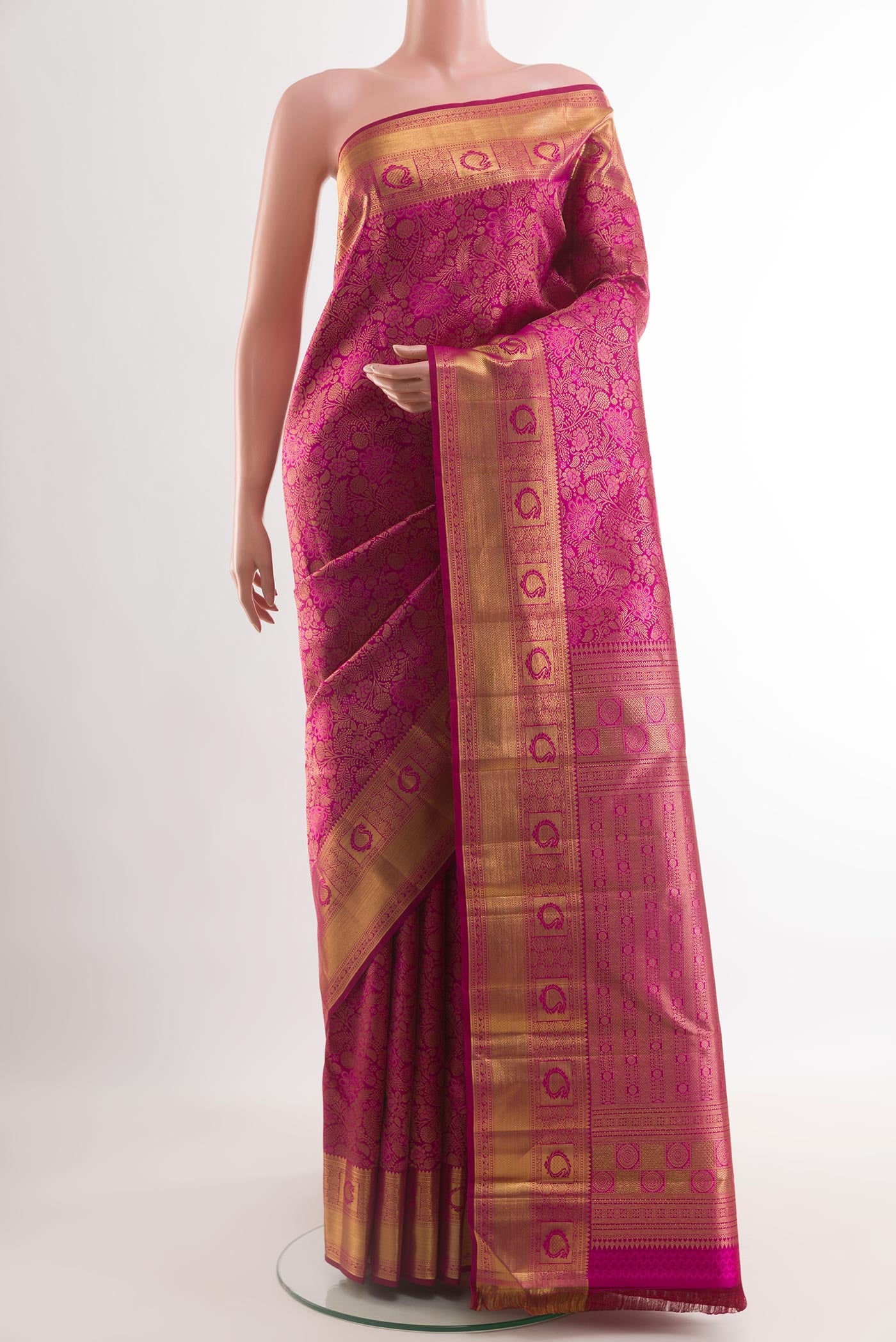 Magenta Kanchipuram Silk Saree with Zari Brocade on the body and Zari Border.  displayed on a mannequin