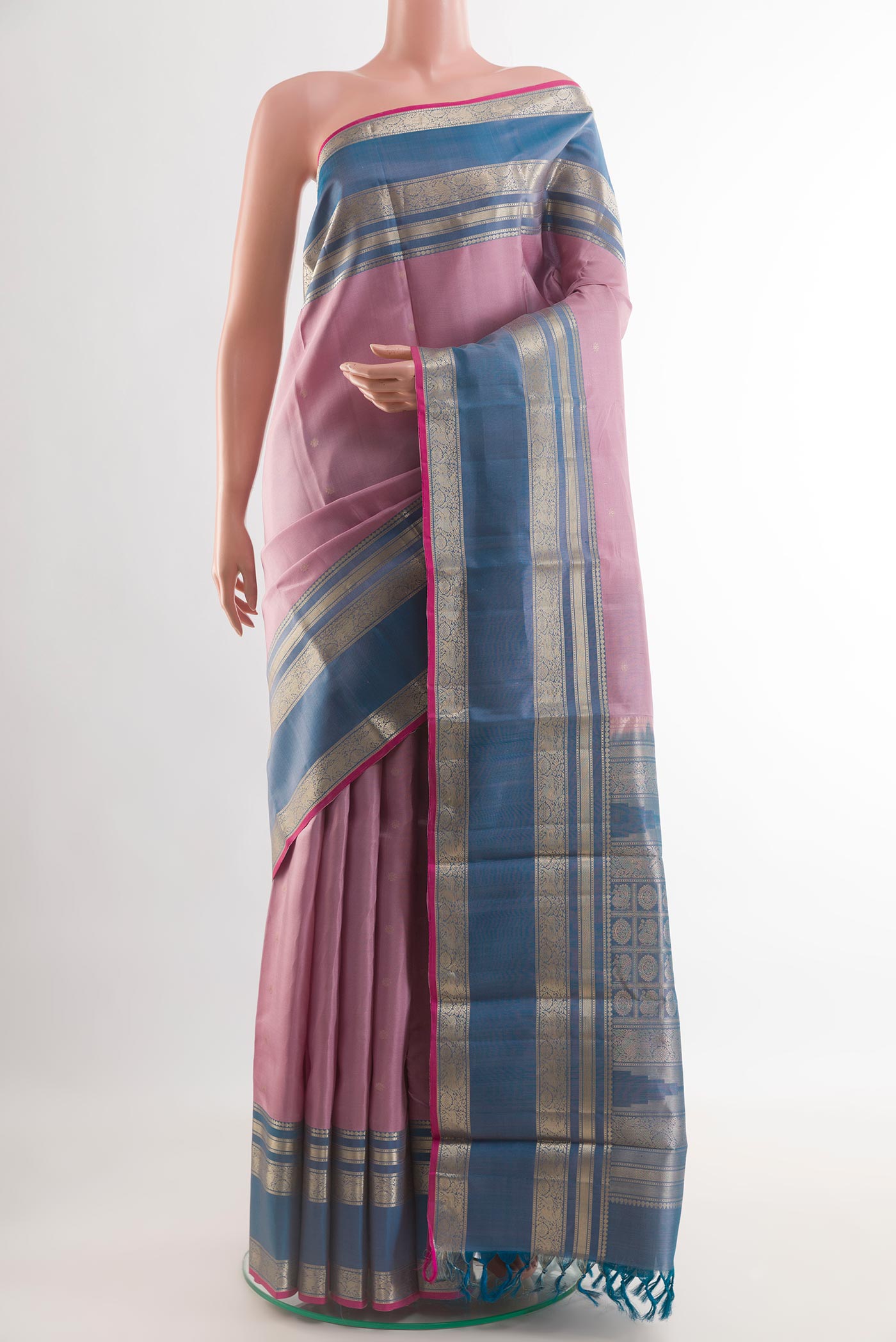 Lavender Kanchipuram Silk Saree with Zari Butta on the body and Zari Border.  displayed on a mannequin