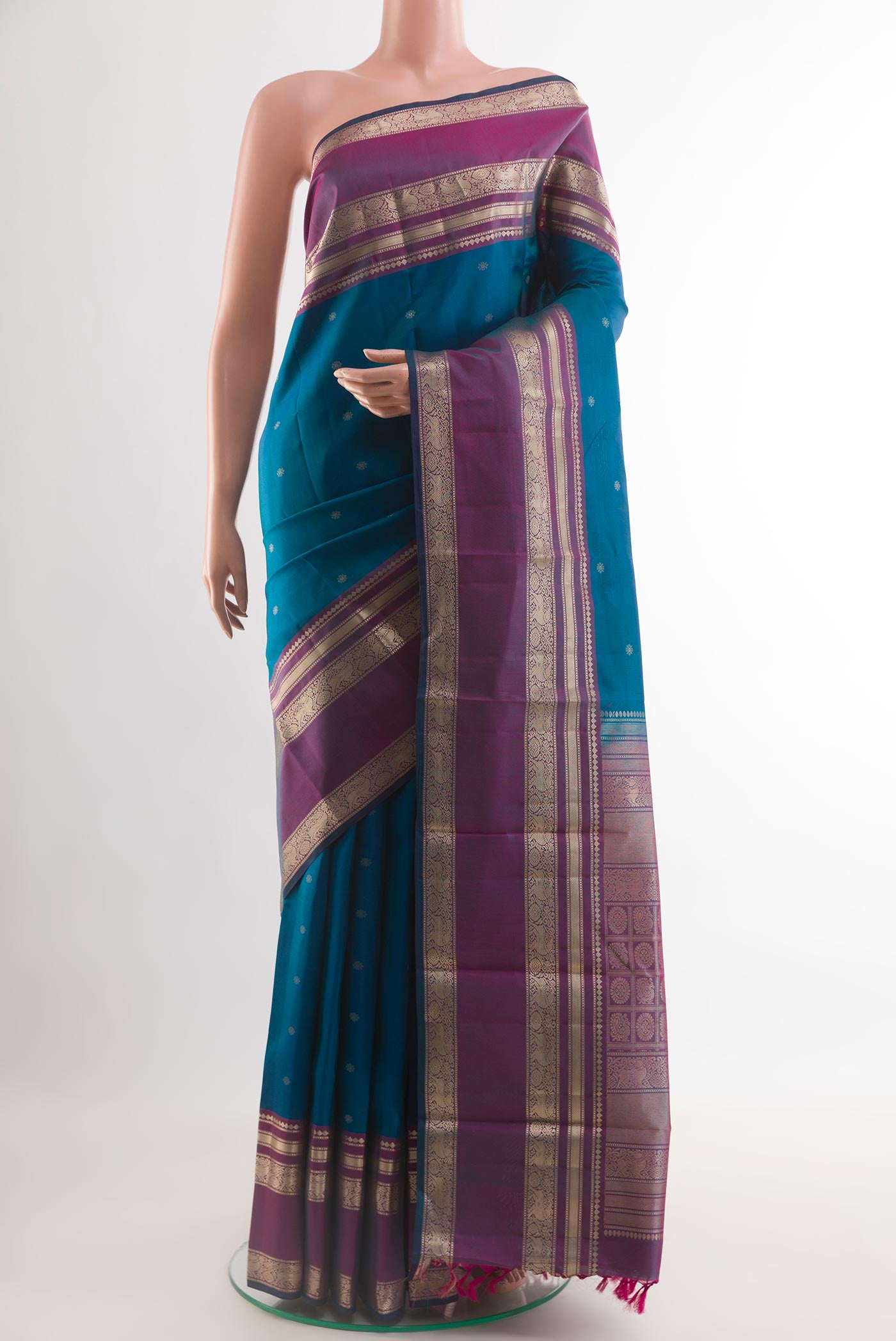 Blue Kanchipuram Silk Saree with Zari Butta on the body and Zari Border.  displayed on a mannequin