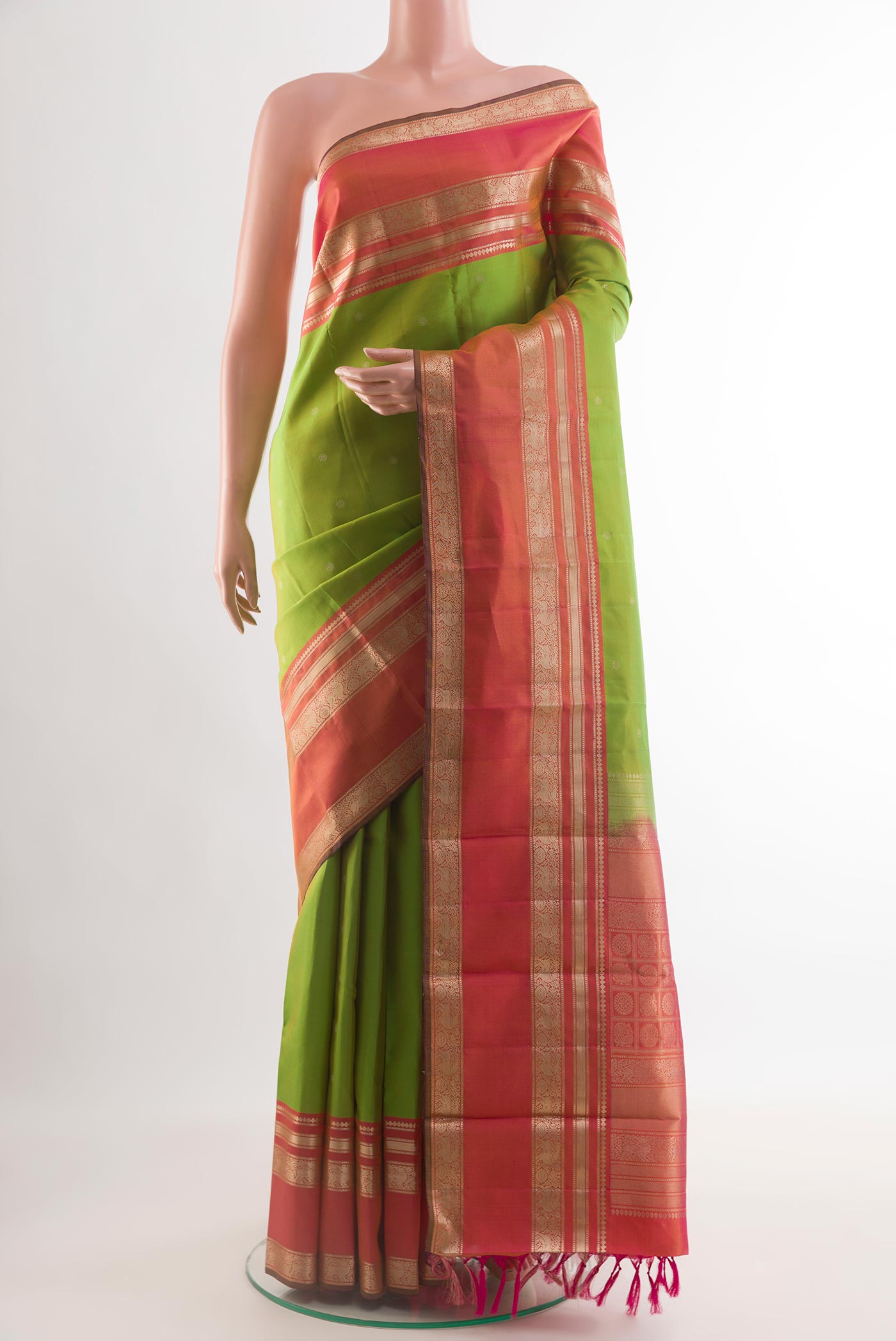 Green Kanchipuram Silk Saree with Zari Butta on the body and Zari Border.  displayed on a mannequin