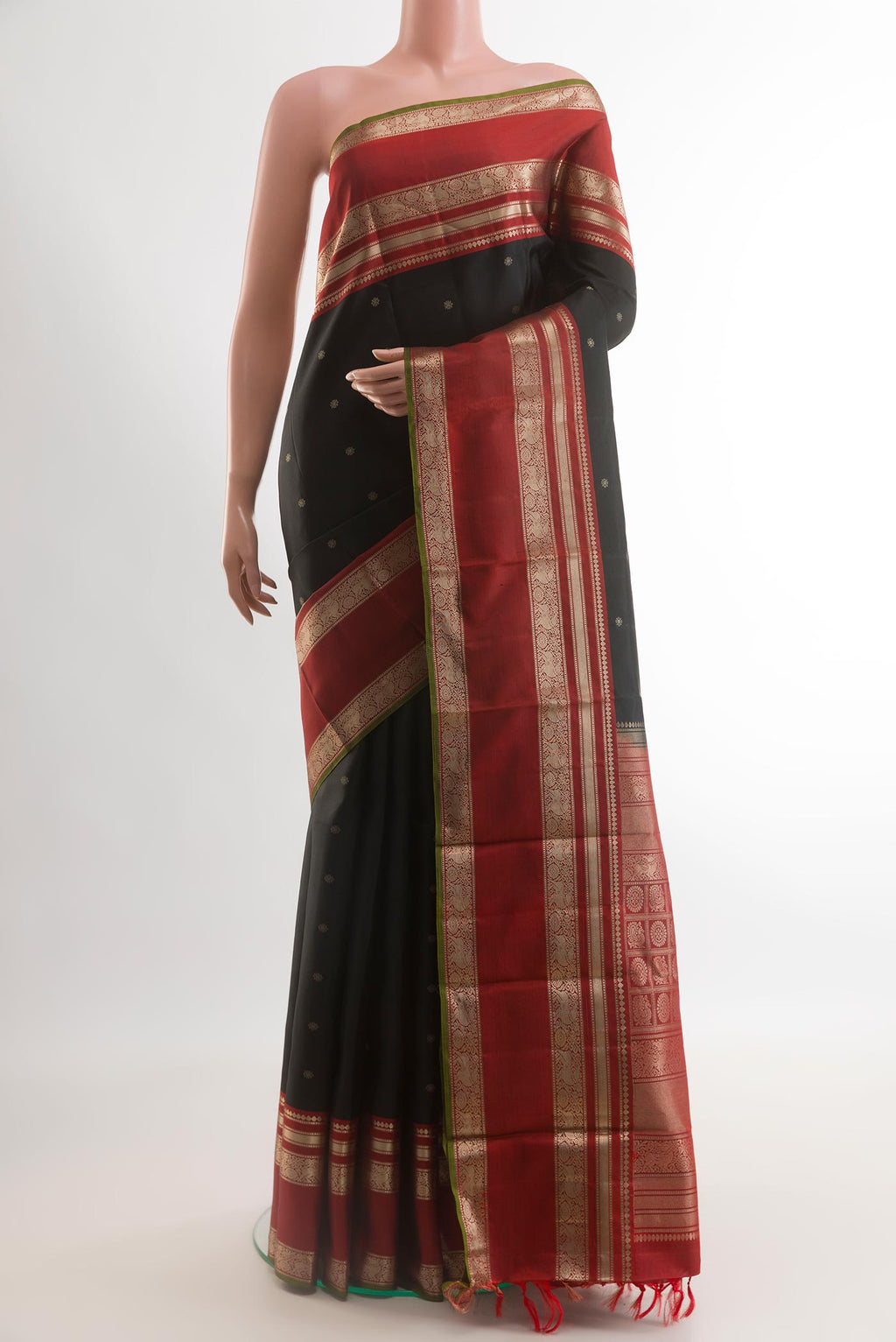 Black Kanchipuram Silk Saree with Zari Butta on the body and Zari Border.  displayed on a mannequin