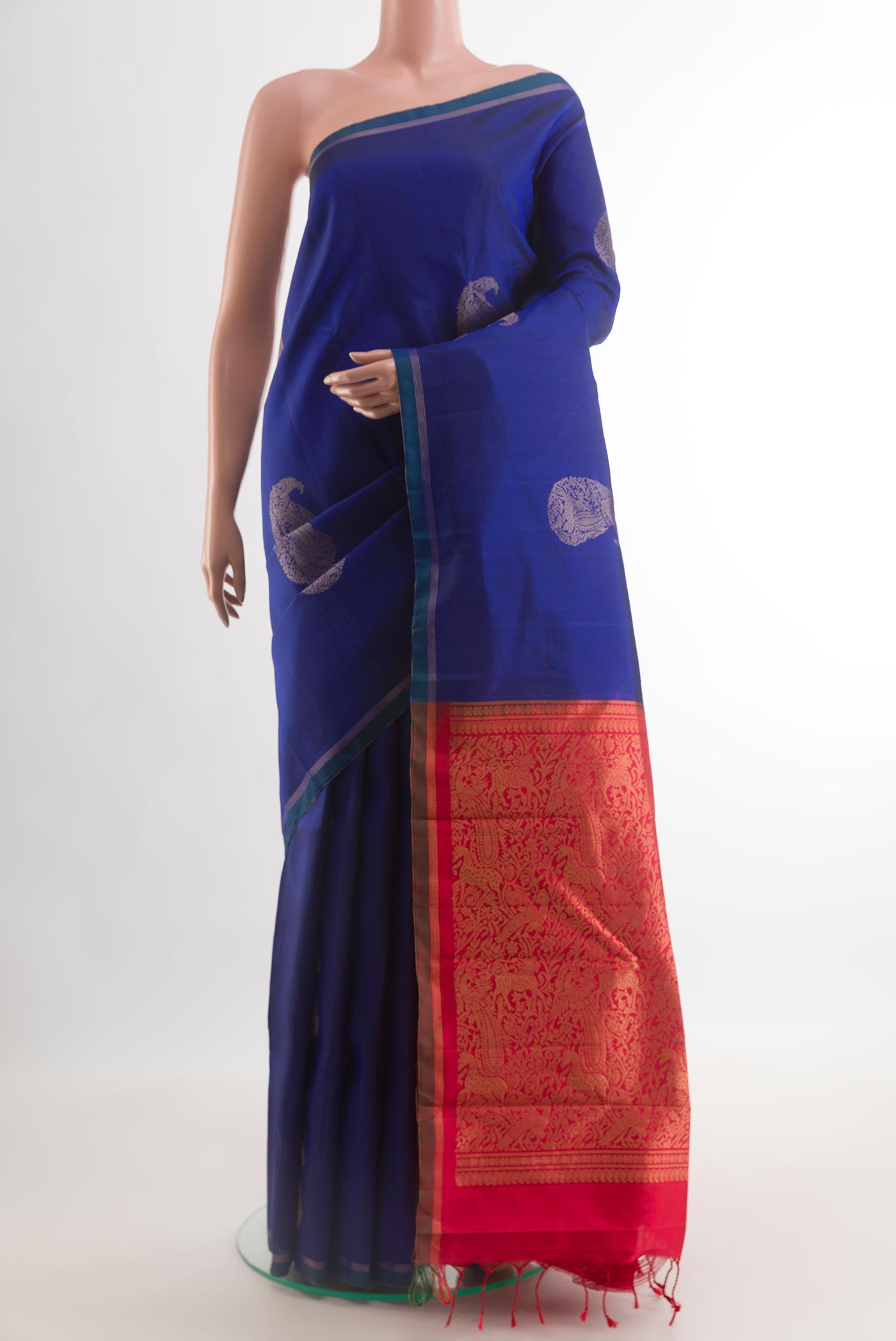 Blue Kanchipuram Silk Saree with Zari Butta on the body and Zari Border.  displayed on a mannequin