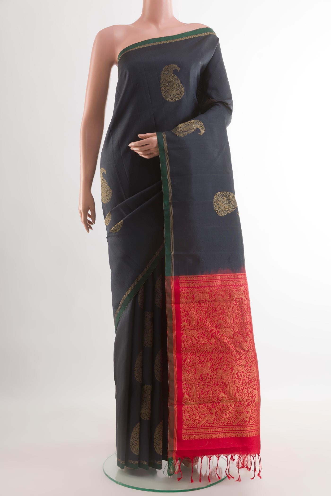 Black Kanchipuram Silk Saree with Zari Butta on the body and Zari Border.  displayed on a mannequin