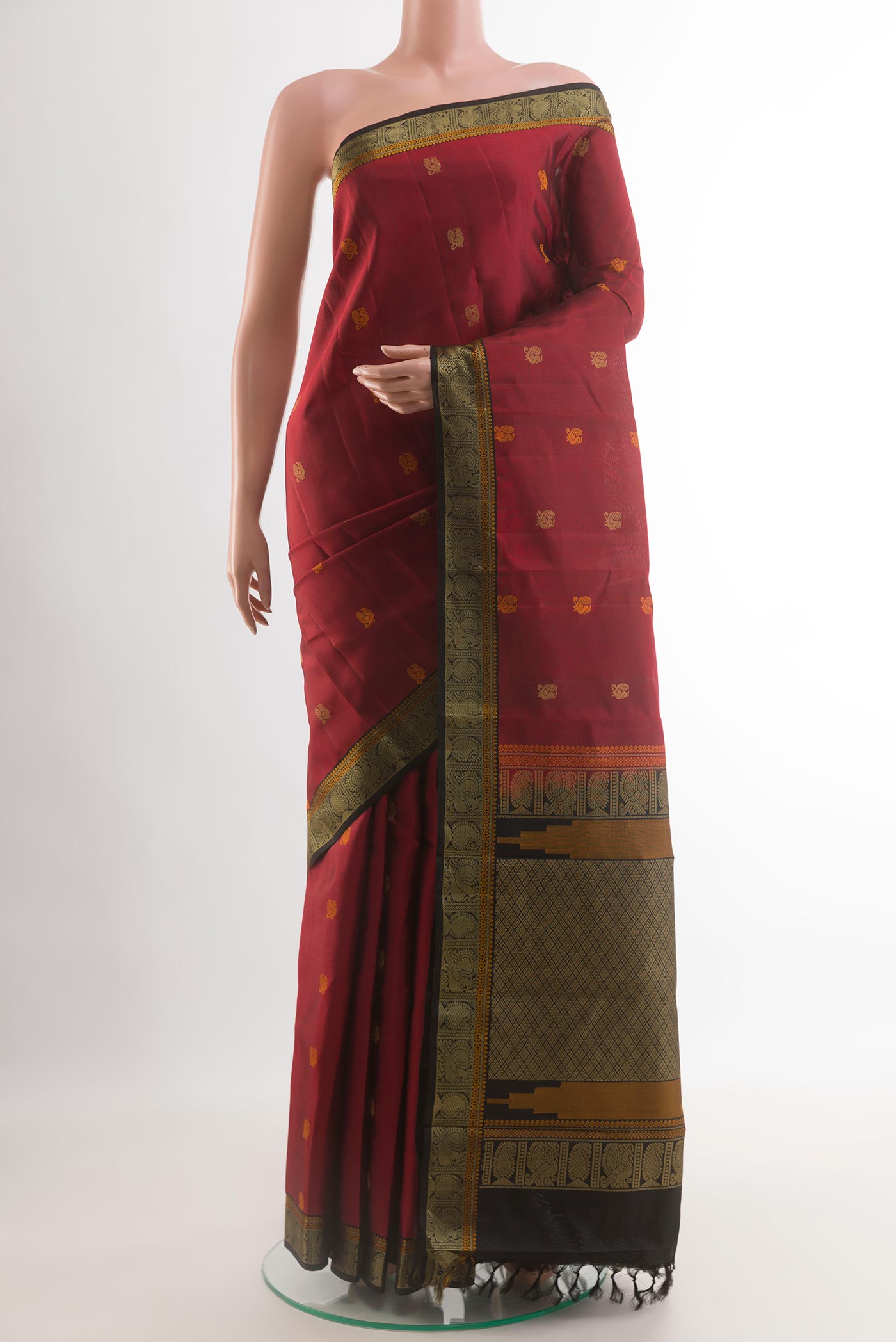 Maroon Kanchipuram Silk Saree with Thread Butta on the body and Thread Border.  displayed on a mannequin
