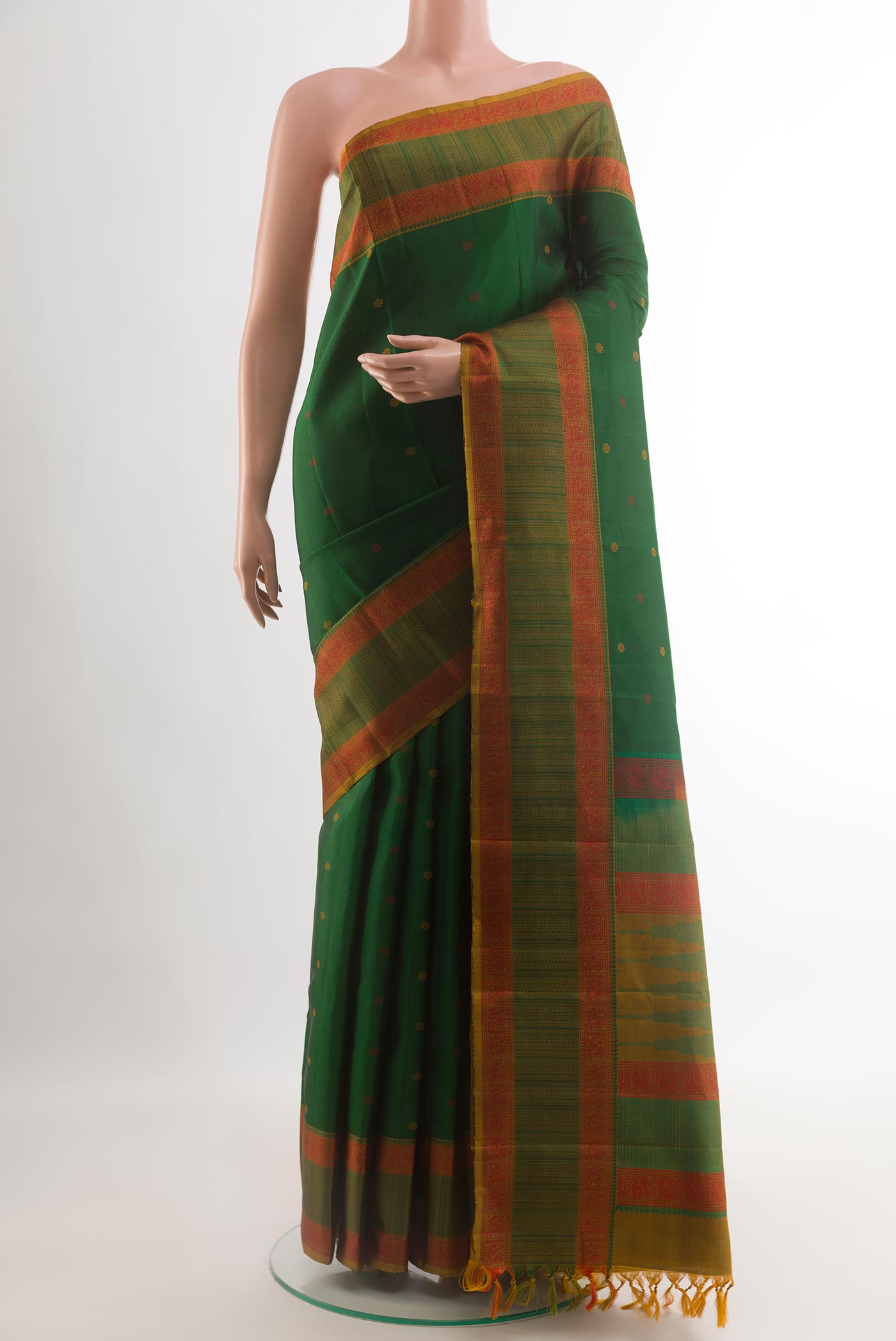 Green Kanchipuram Silk Saree with Thread Butta on the body and Thread Border.  displayed on a mannequin