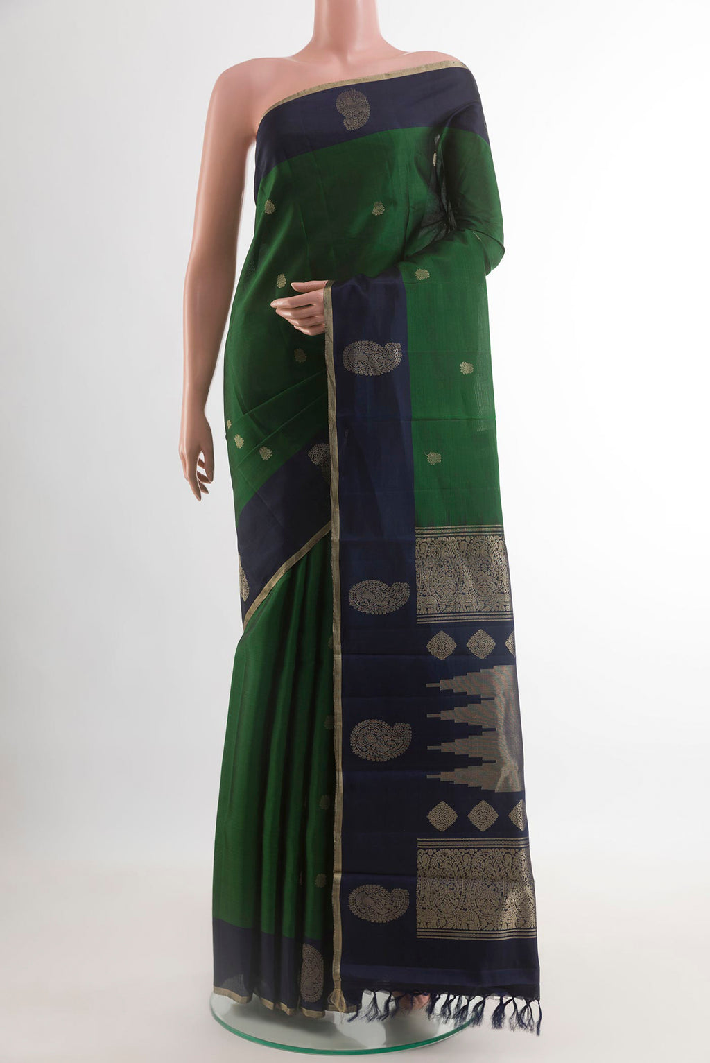 Green Kanjivaram Silk Saree with Zari Butta on the body and Zari Border.  displayed on a mannequin