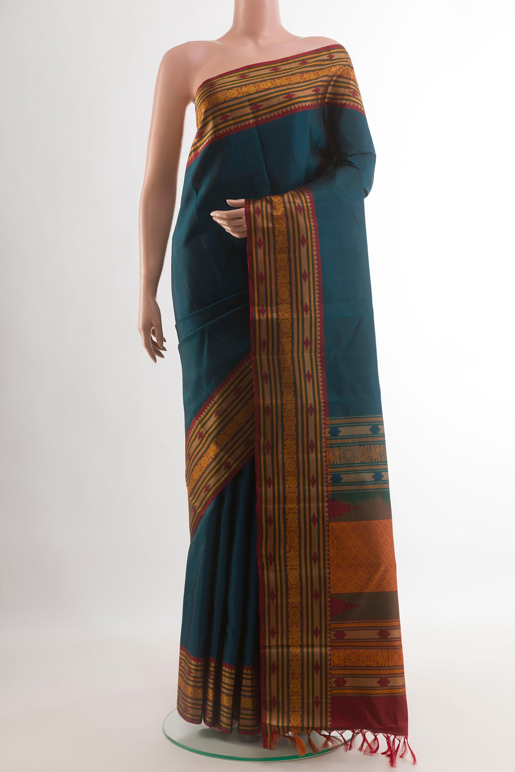 Blue Kanchipuram Silk Saree with Plain Body and Thread Border.  displayed on a mannequin