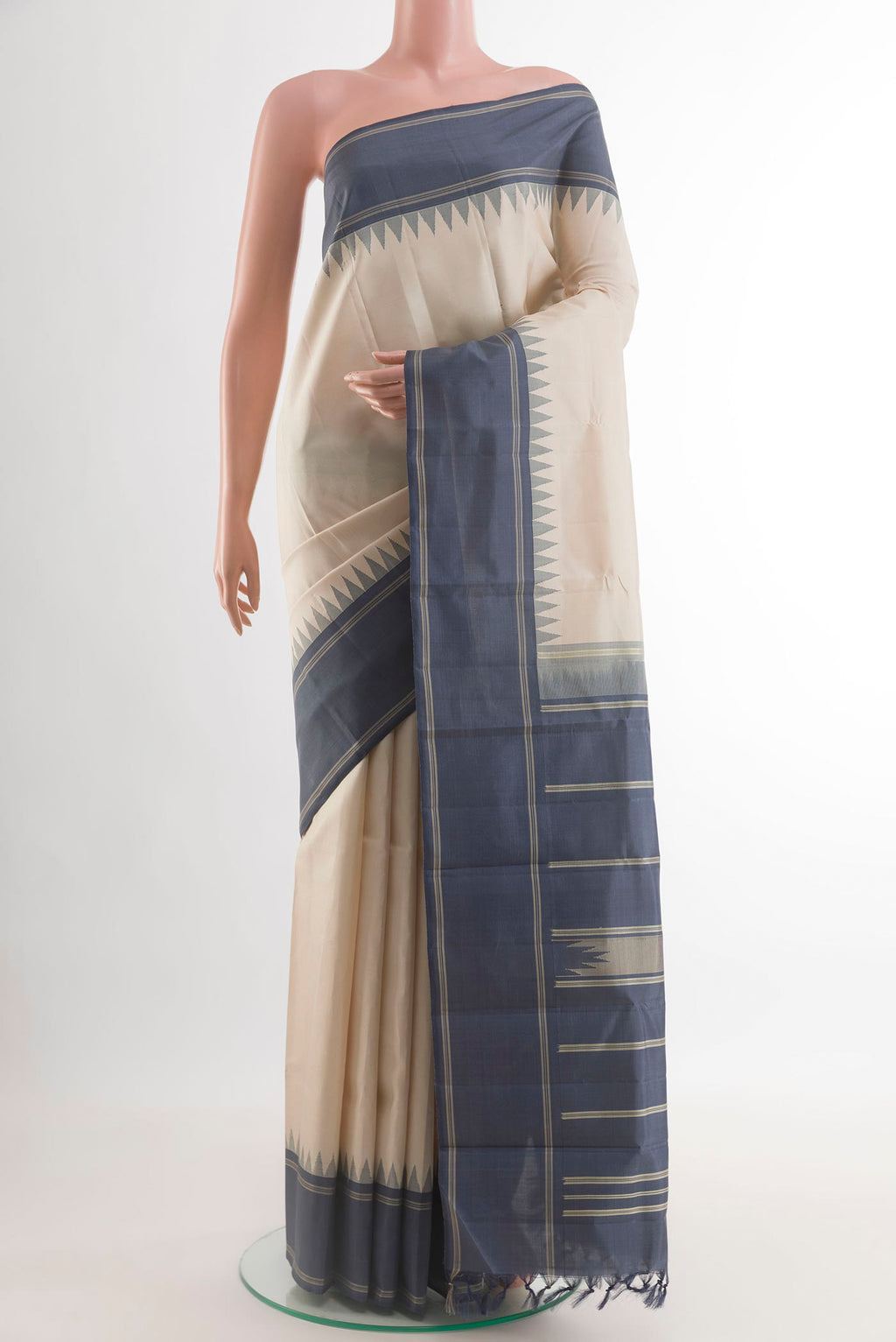 Off White Kanchipuram Silk Saree with Plain Body and Temple Thread Border.  displayed on a mannequin