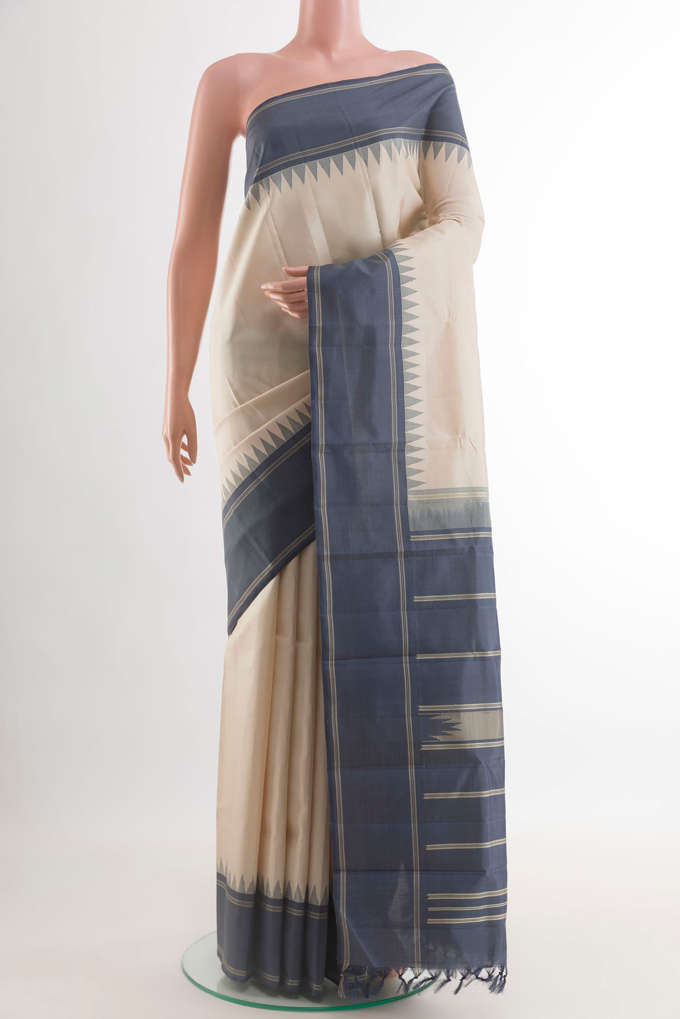 Off White Kanchipuram Silk Saree with Plain Body and Temple Thread Border.  displayed on a mannequin