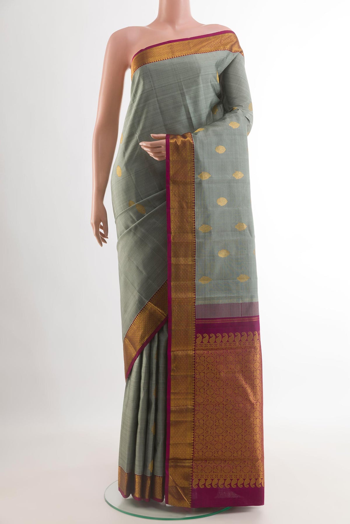 Grey Kanchipuram Silk Saree with Zari Butta on the body and Zari Border.  displayed on a mannequin