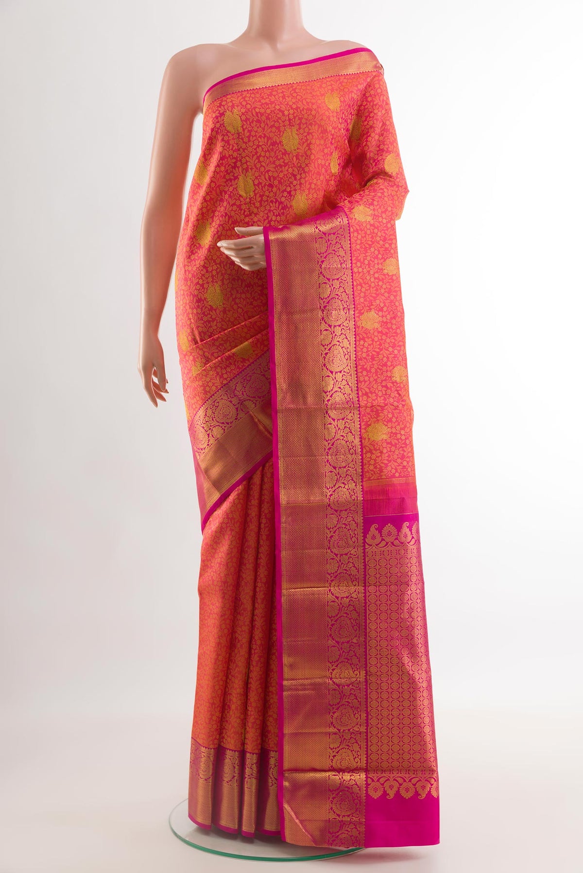 Coral Kanjivaram Silk Saree with Jacquard With Zari Butta on the body and Zari Border.  displayed on a mannequin