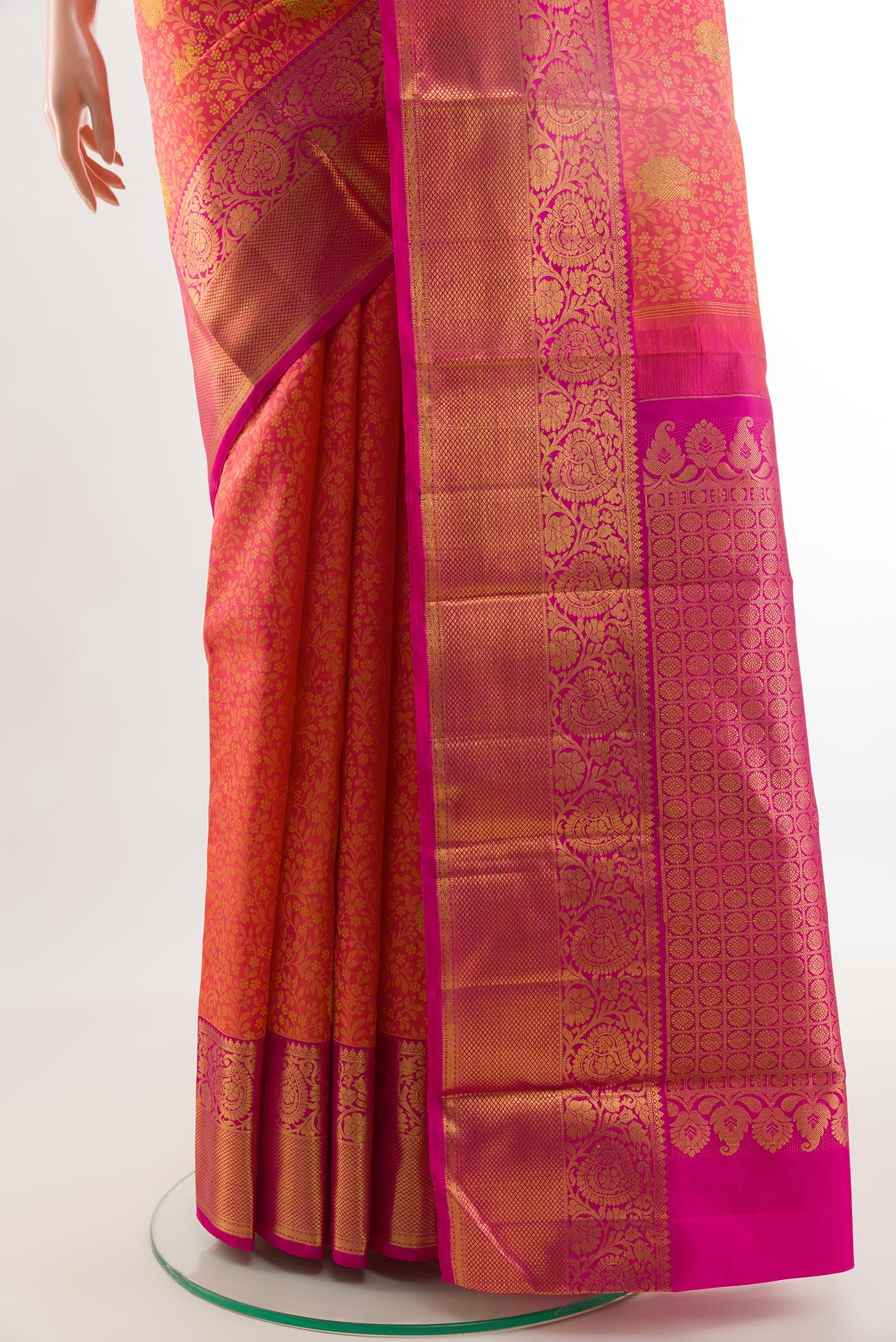 Pleats and pallu of Coral Kanjivaram Silk Saree with Jacquard With Zari Butta on the body and Zari Border. 