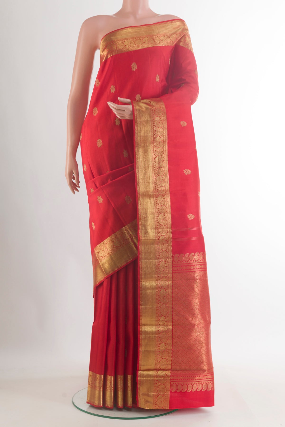 Pure Silk Pure Zari Red Kanchipuram Saree with Zari Butta on the body and Zari Border.  displayed on a mannequin