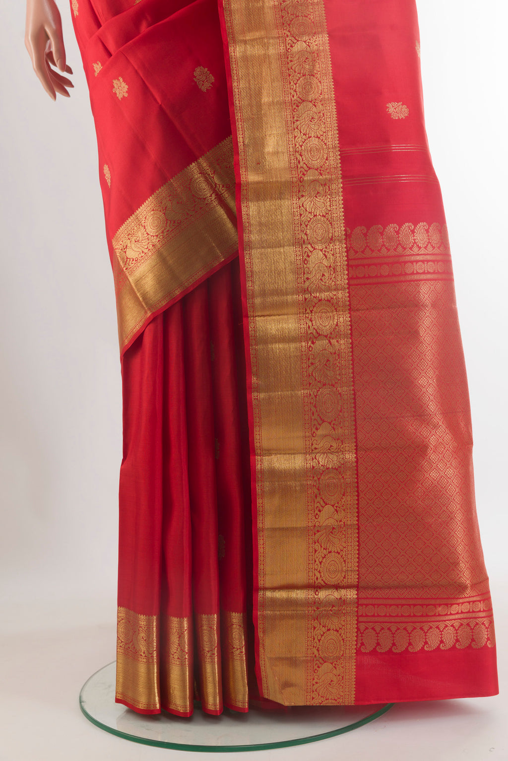 Pleats and pallu of Pure Silk Pure Zari Red Kanchipuram Saree with Zari Butta on the body and Zari Border. 