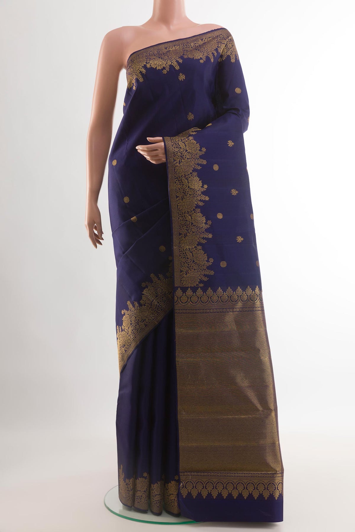 Navy Blue Kanjivaram Silk Saree with Zari Butta on the body and Zari Border.  displayed on a mannequin