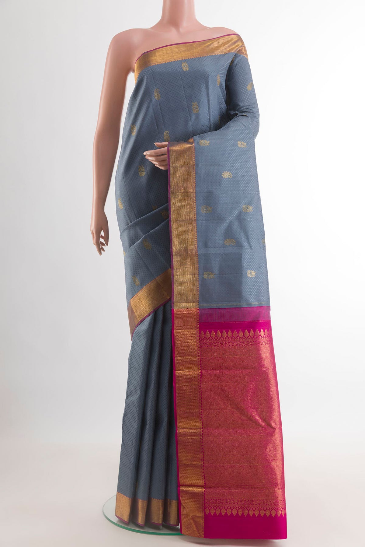 Grey Kanjivaram Silk Saree with Jacquard With Zari Butta on the body and Zari Border.  displayed on a mannequin