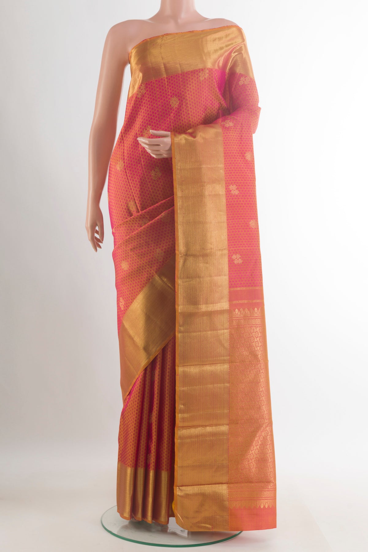 Pure Silk Brick Orange Dual Tone Kanjivaram Saree with Jacquard With Zari Butta on the body and Zari Border.  displayed on a mannequin