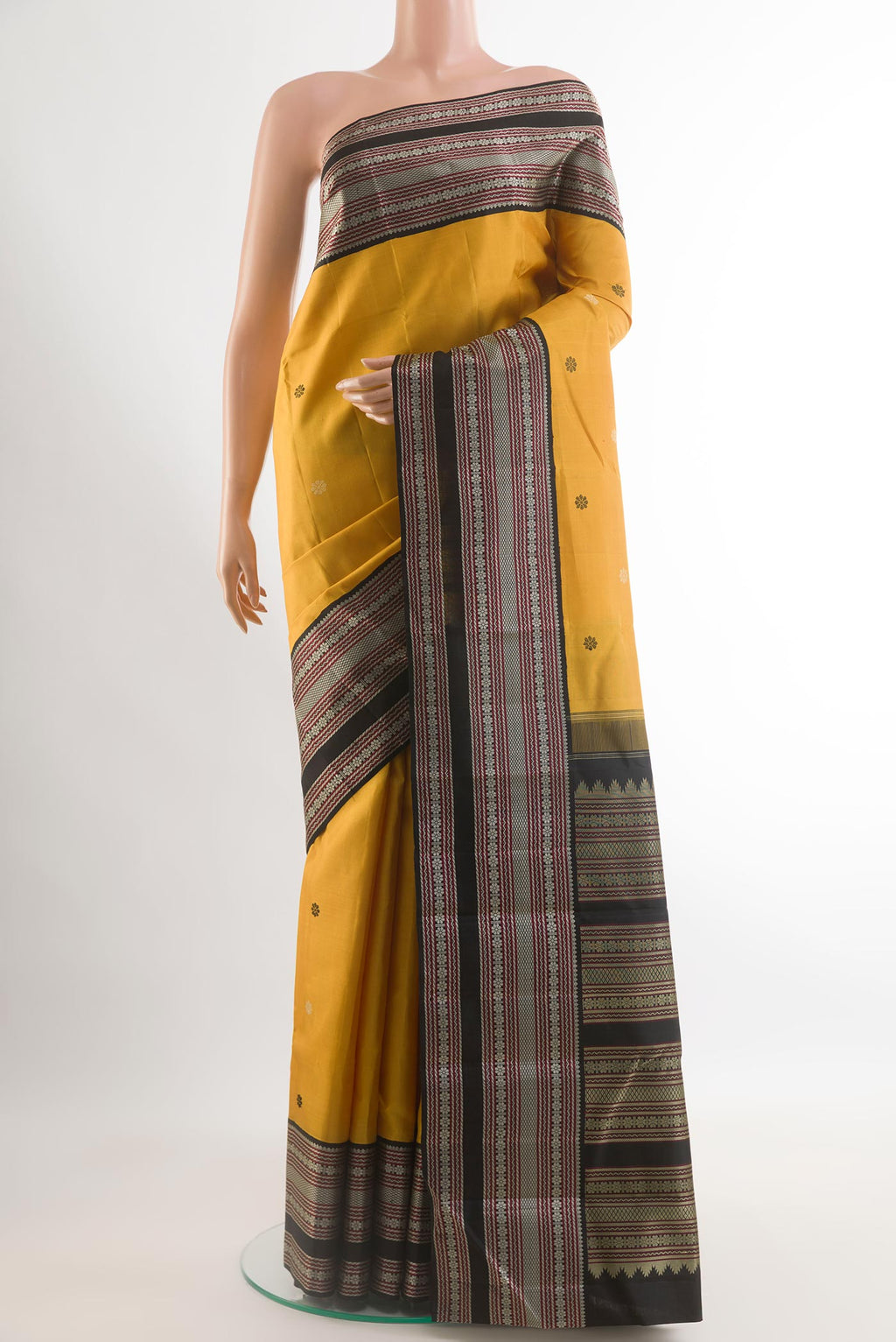 Yellow Kanjivaram Silk Saree with Thread Butta on the body and Thread Embroidery Border.  displayed on a mannequin