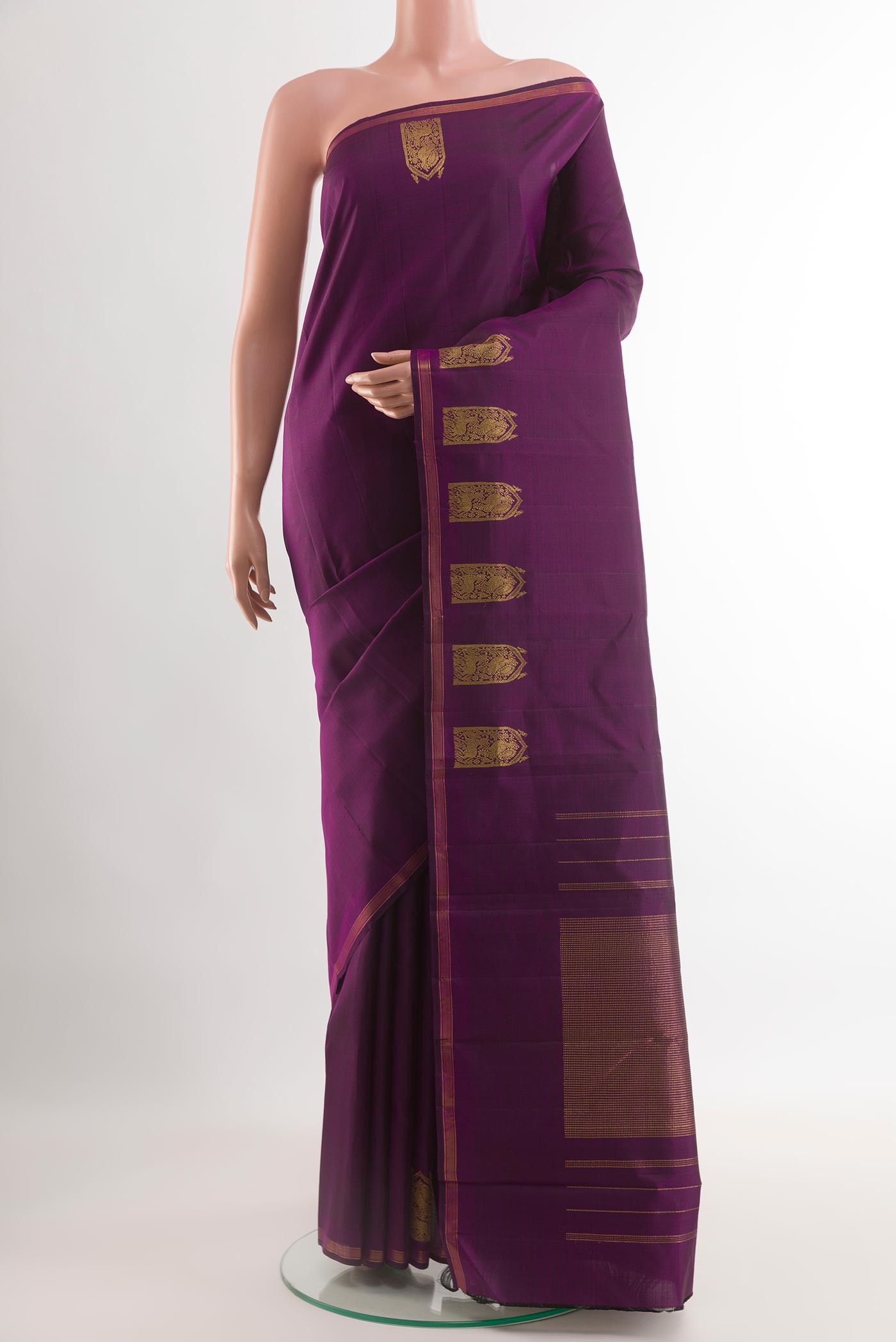 Violet Kanchipuram Silk Saree with Plain Body and Zari Border.  displayed on a mannequin
