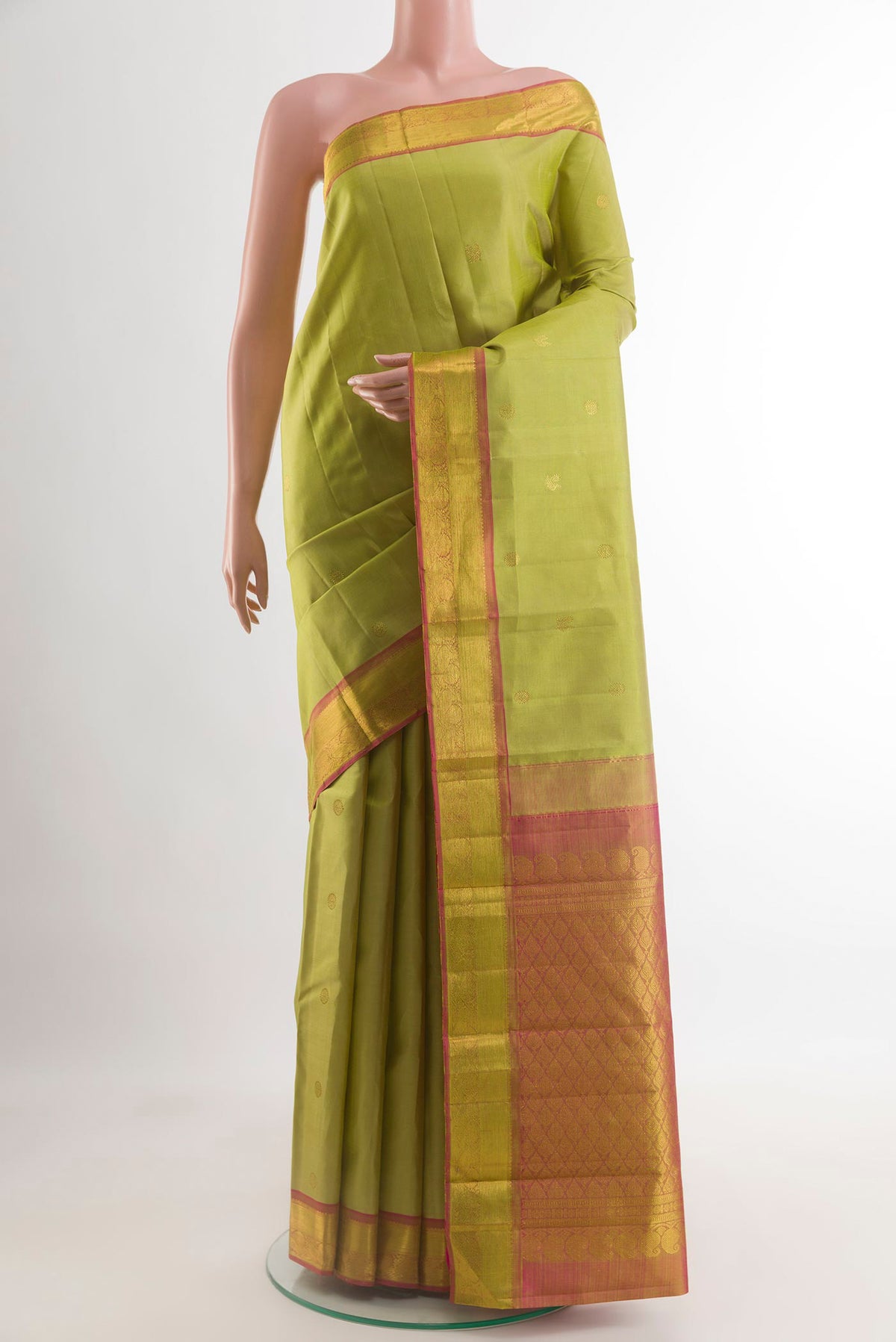 Light Green Kanjivaram Silk Saree with Zari Butta on the body and Zari Border.  displayed on a mannequin
