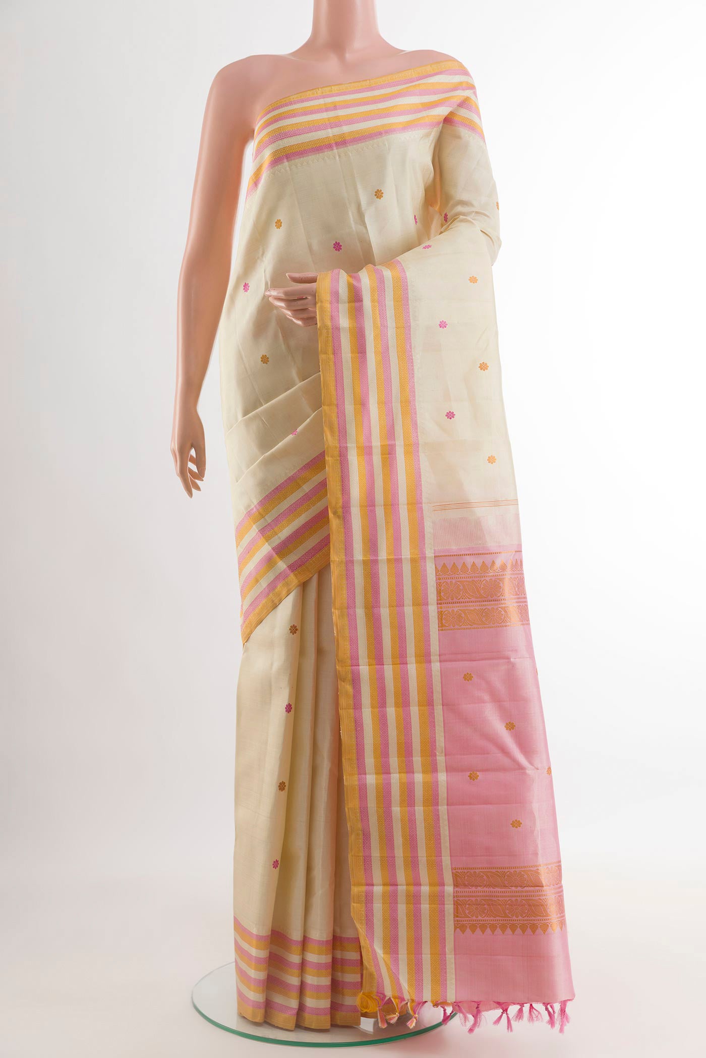 Off White Kanjivaram Silk Saree with Thread Butta on the body and Thread Border.  displayed on a mannequin