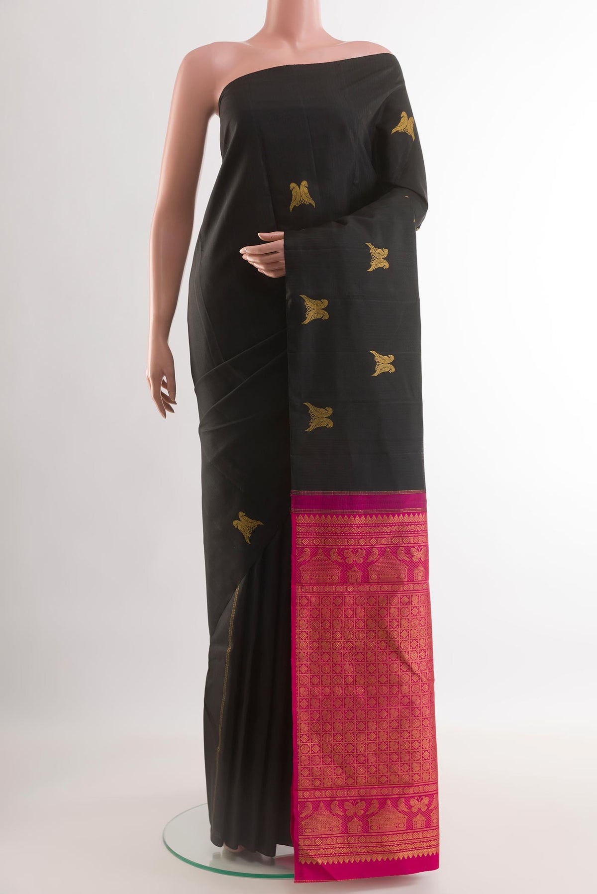 Black Kanchipuram Silk Saree with Zari Butta on the body and Without Border.  displayed on a mannequin