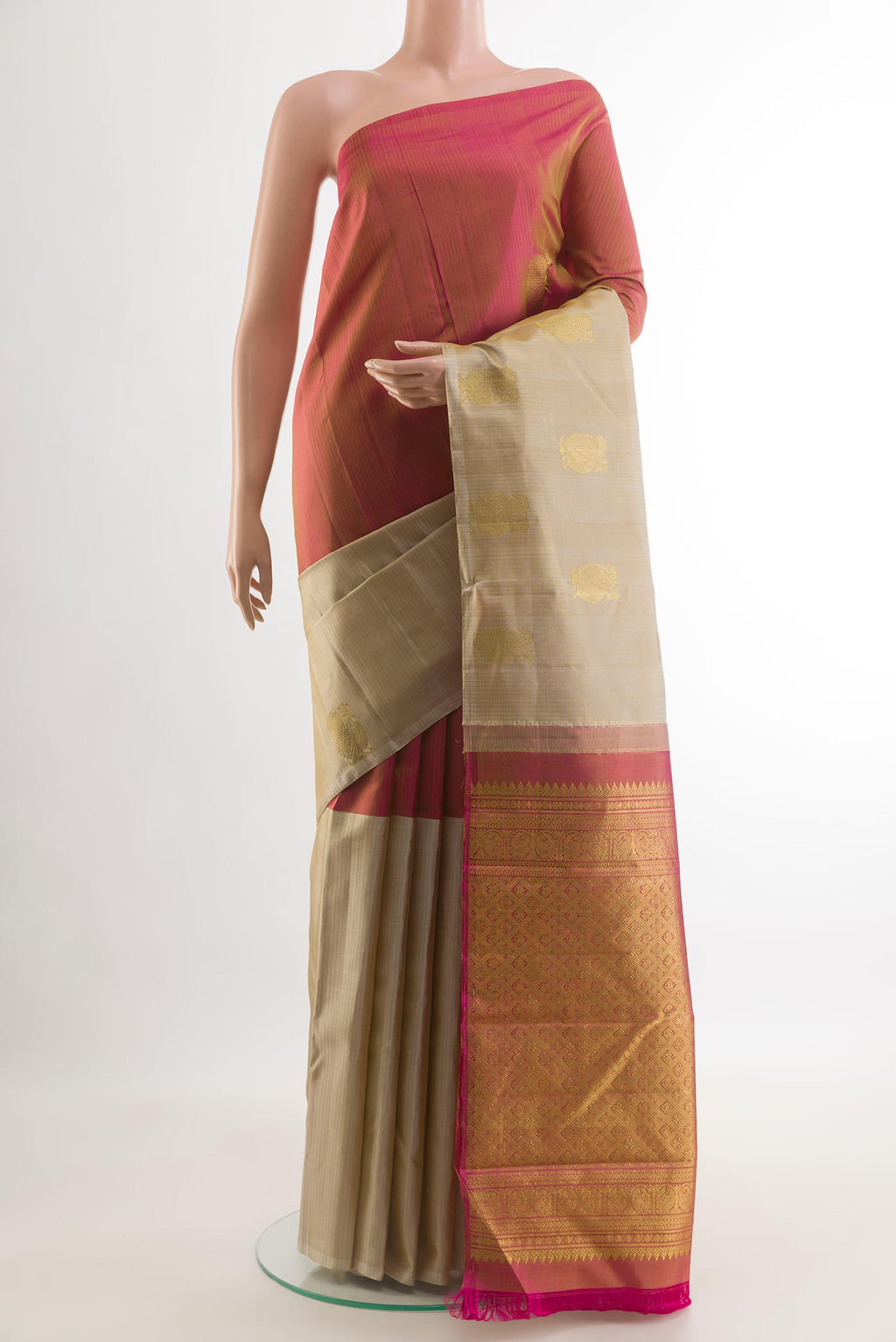 Beige Kanchipuram Silk Saree with Zari Butta on the body and Zari Border.  displayed on a mannequin