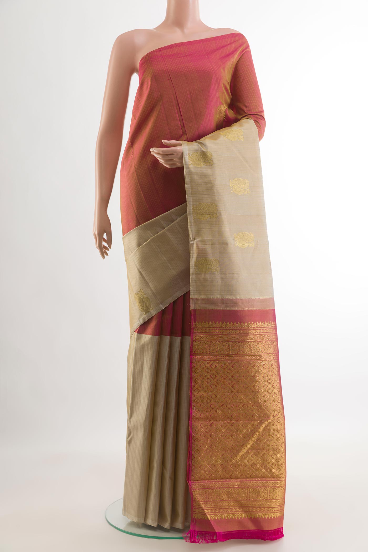 Beige Kanchipuram Silk Saree with Zari Butta on the body and Zari Border.  displayed on a mannequin