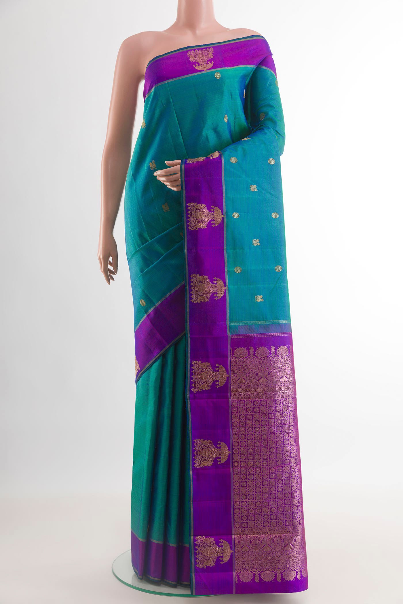 Peacock Blue Kanjivaram Silk Saree with Zari Butta on the body and Fancy Border.  displayed on a mannequin