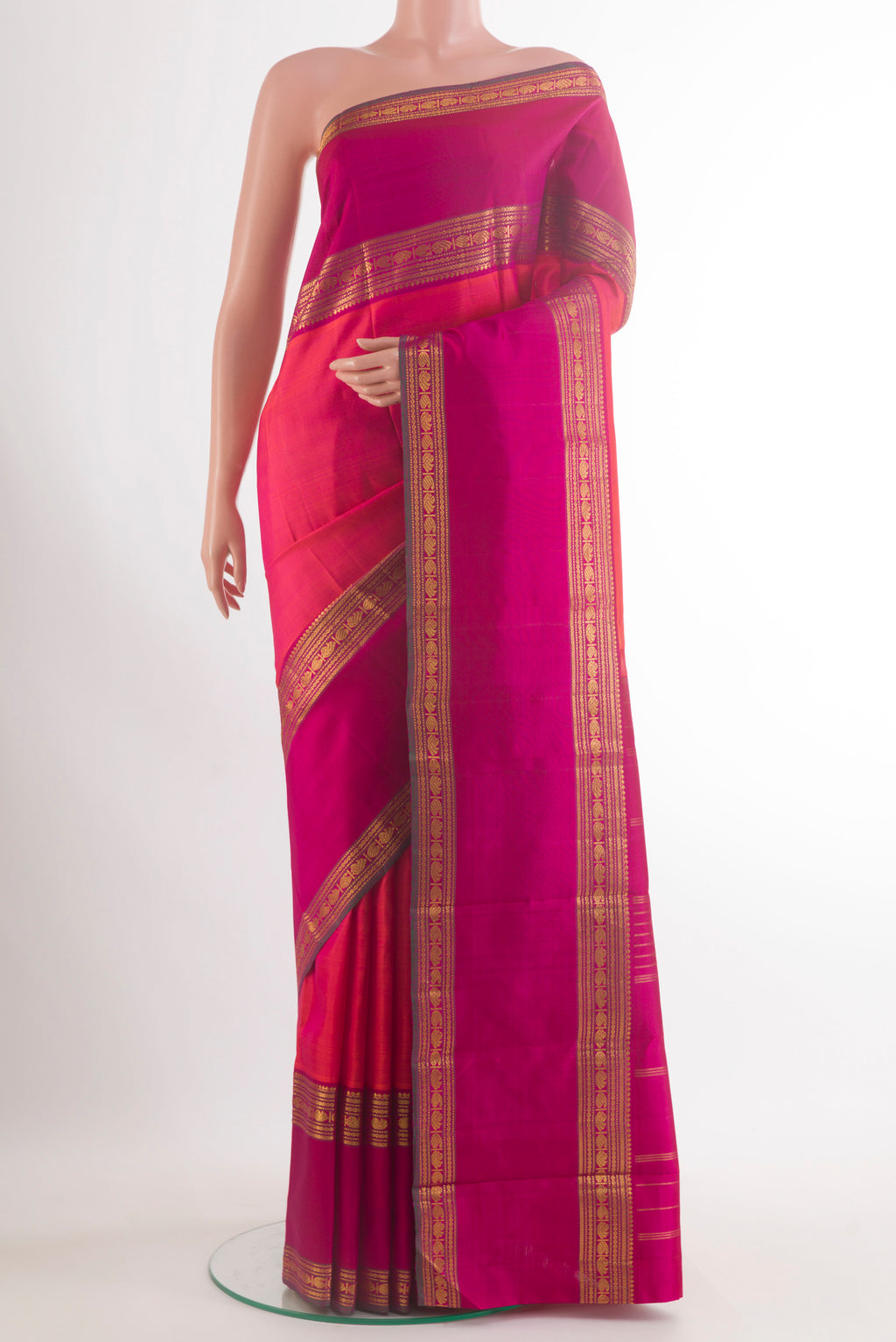 Pure Silk Coral Kanjivaram Saree with Zari Butta on the body and Zari Border.  displayed on a mannequin