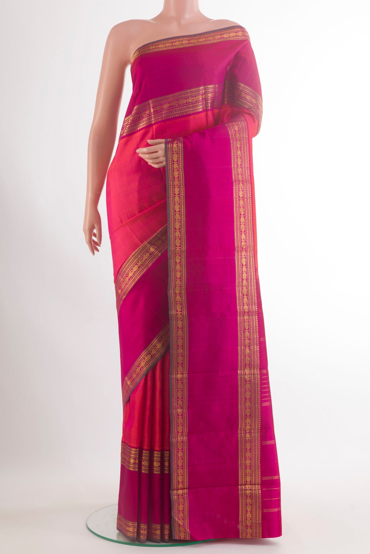Pure Silk Coral Kanjivaram Saree with Zari Butta on the body and Zari Border.  displayed on a mannequin