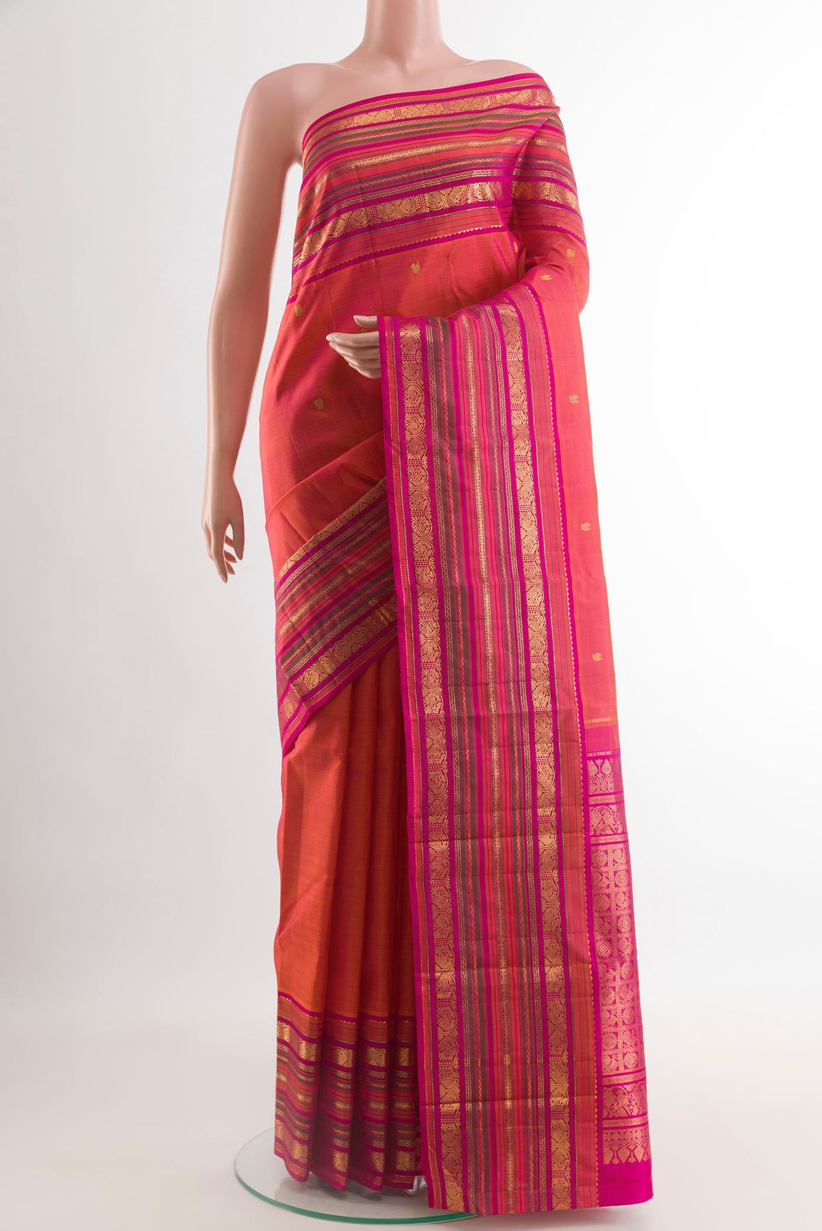 Coral Dual Tone Kanjivaram Silk Saree with Zari Butta on the body and Zari Border.  displayed on a mannequin