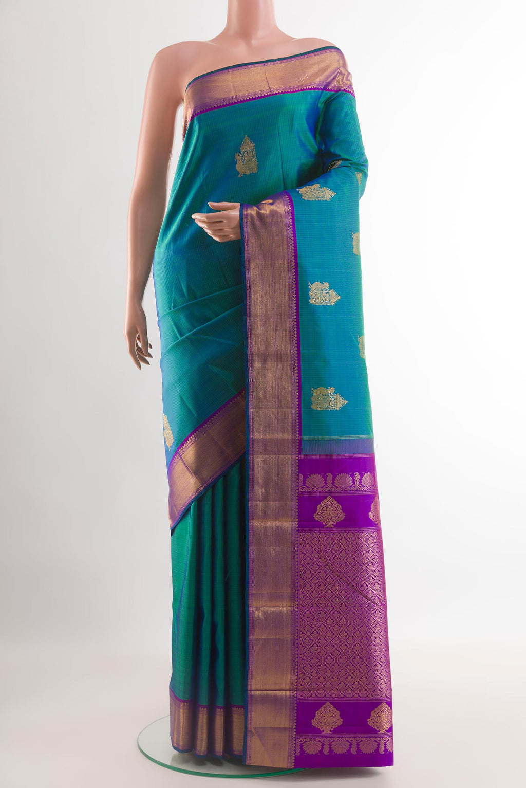 Peacock Blue Kanjivaram Silk Saree with Zari Butta on the body and Zari Border.  displayed on a mannequin